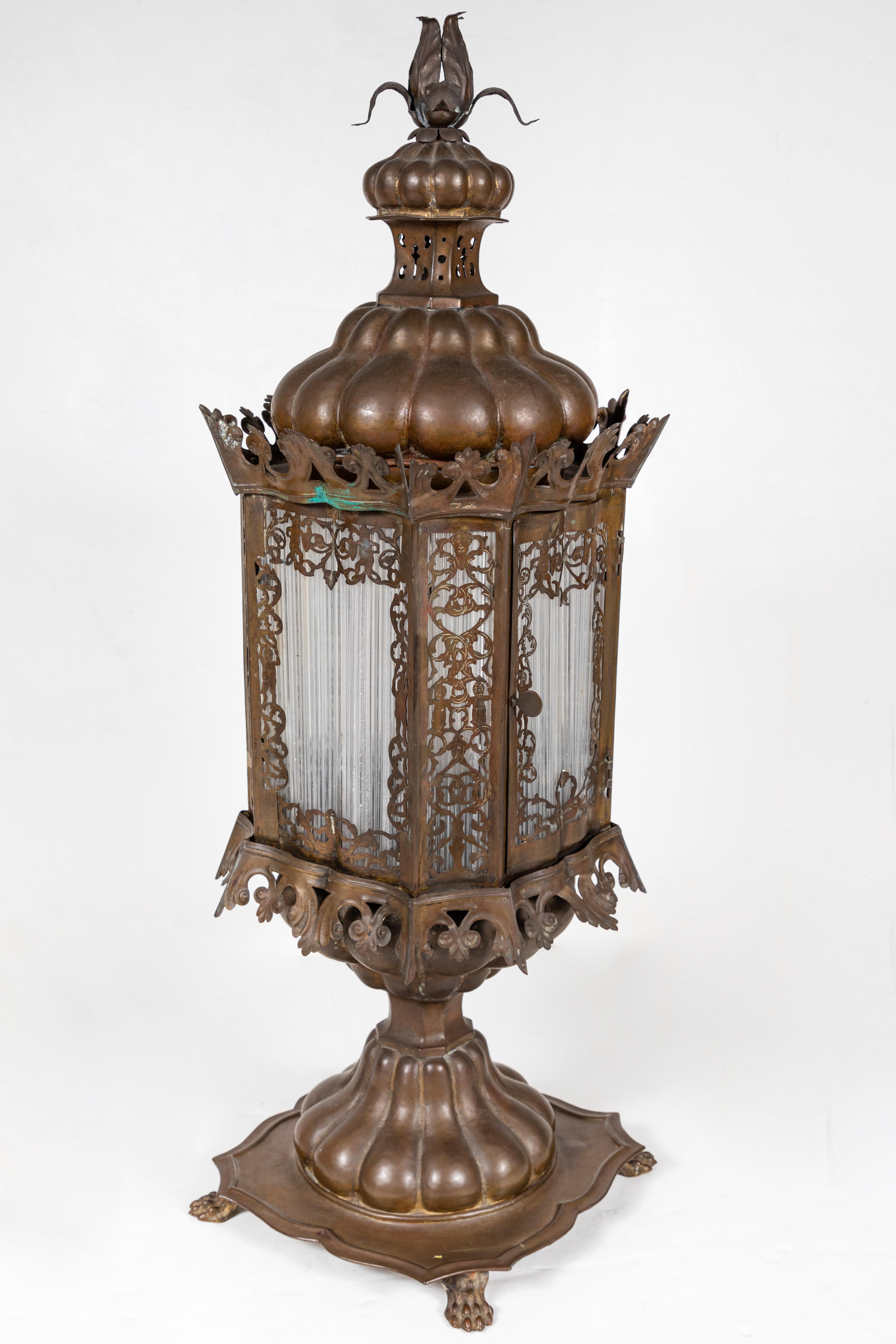 A stunning pair of pierced, hand - done, copper lanterns featuring four opaque, Murano glass-tube windows surrounded by foliate forms and figures. Each with lobed bases and tops, rising to an unfurling, floral finial. Wired for U.S. current.