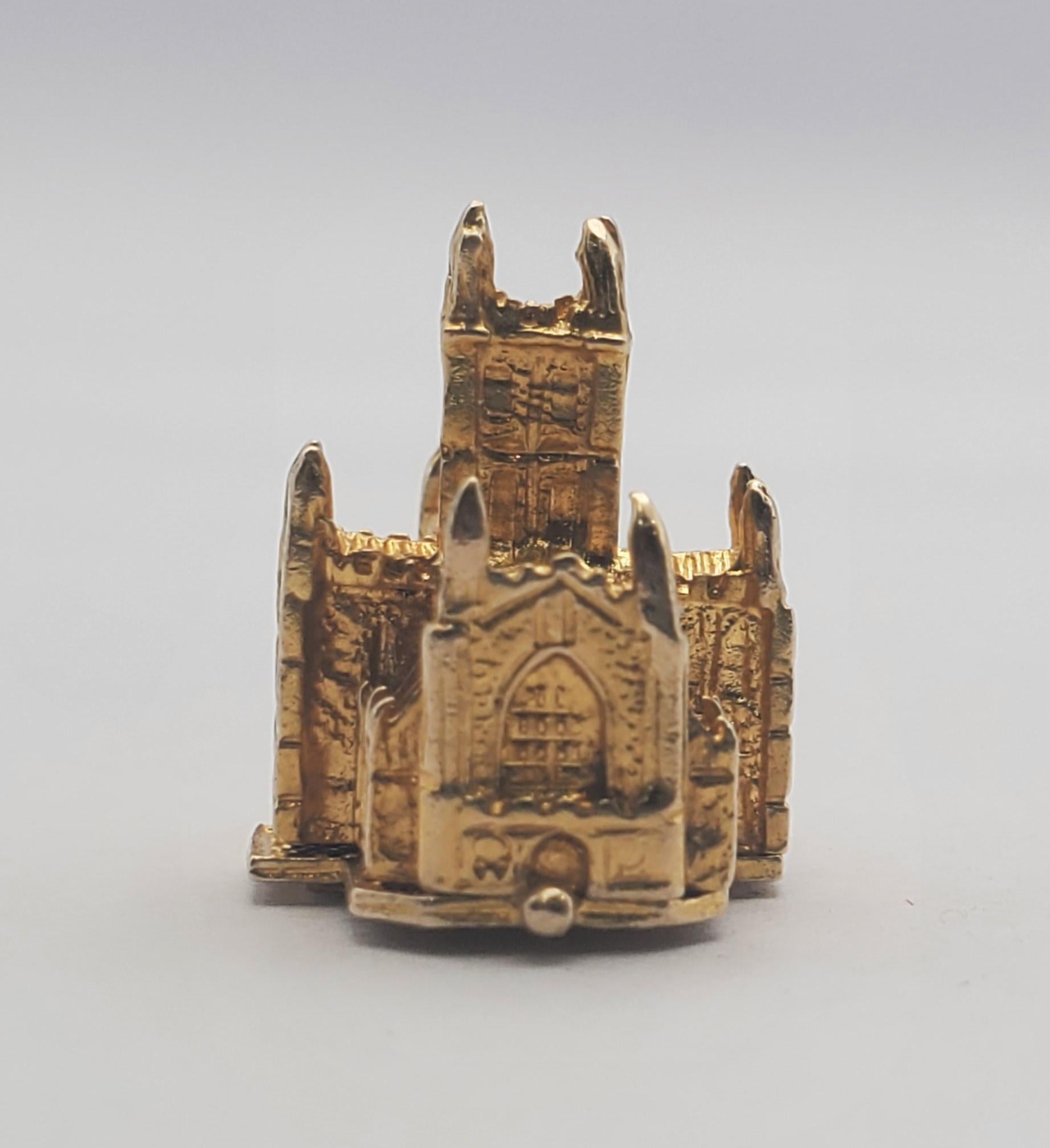 Ornately detailed 9K yellow gold cathedral charm featuring an adorable wedding scene hidden within. The cathedral design is of Hereford Cathedral, located on the western side of the UK in Hereford, Herefordshire. The cathedral is one of the UK's