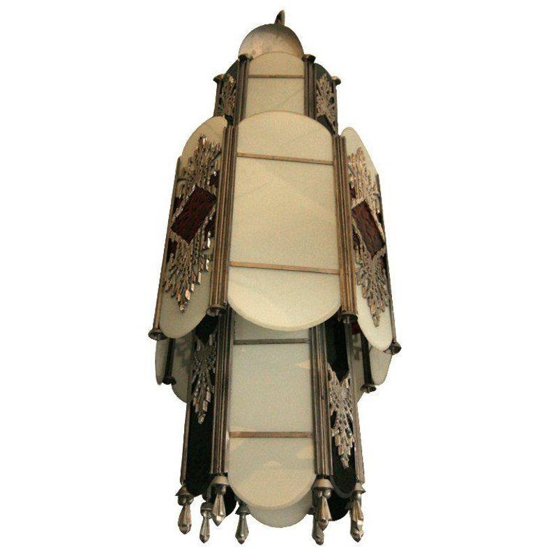 This stunning Art Deco chandelier features red and green stained glass as well as flashed opal glass with intricate aluminum cast inserts. This chandelier come out of the Hollywood Grauman's Chinese Theatre which originally opened in 1927.

The