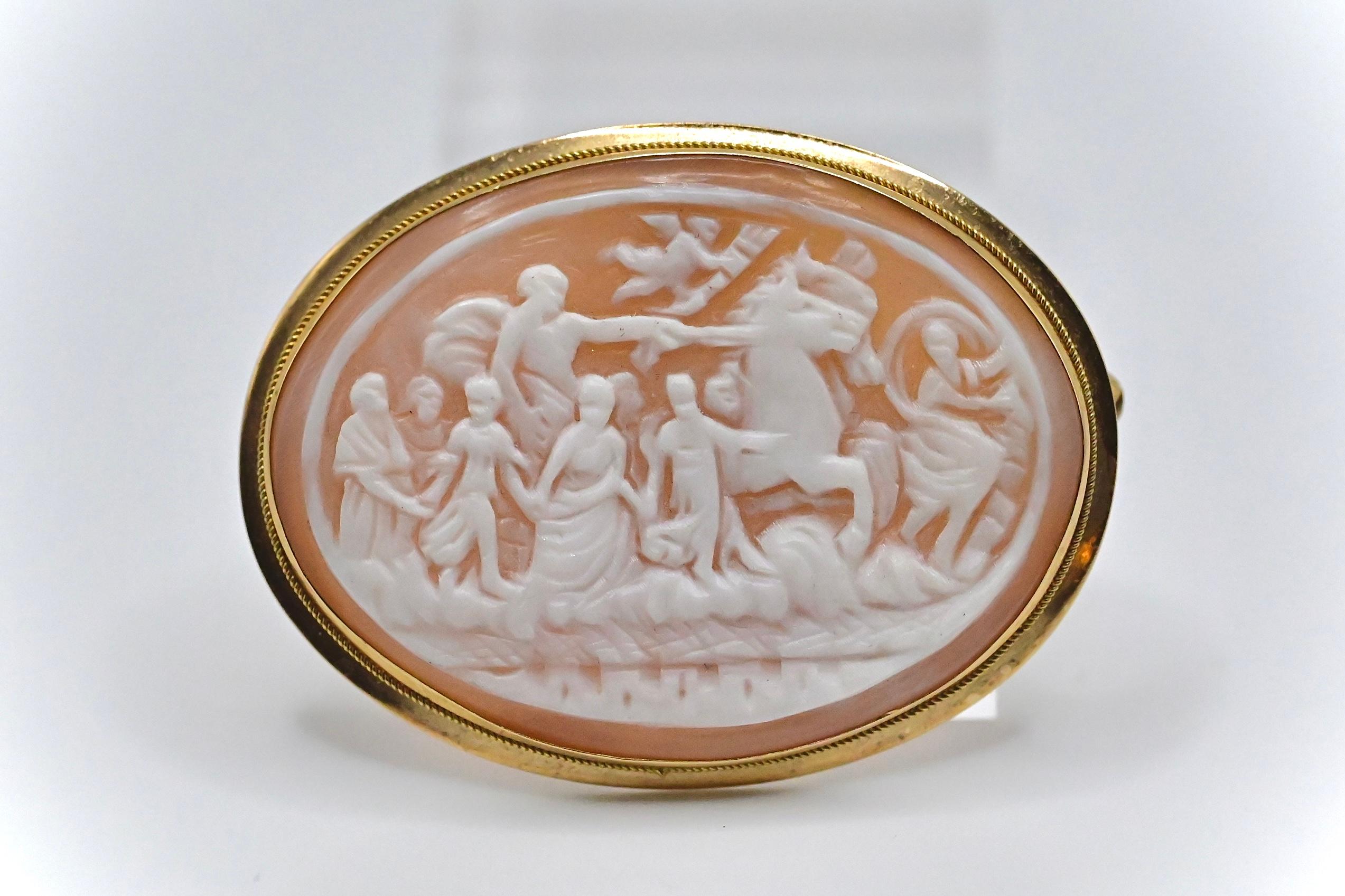 This is an exquisite 18k gold carved shell cameo brooch that tells a story on its design. It weighs 8 grams, stands at 1 2/8 inches, and has a 1 11/16 inch diameter. It’s in good condition with little wear, and If you have any questions or concerns
