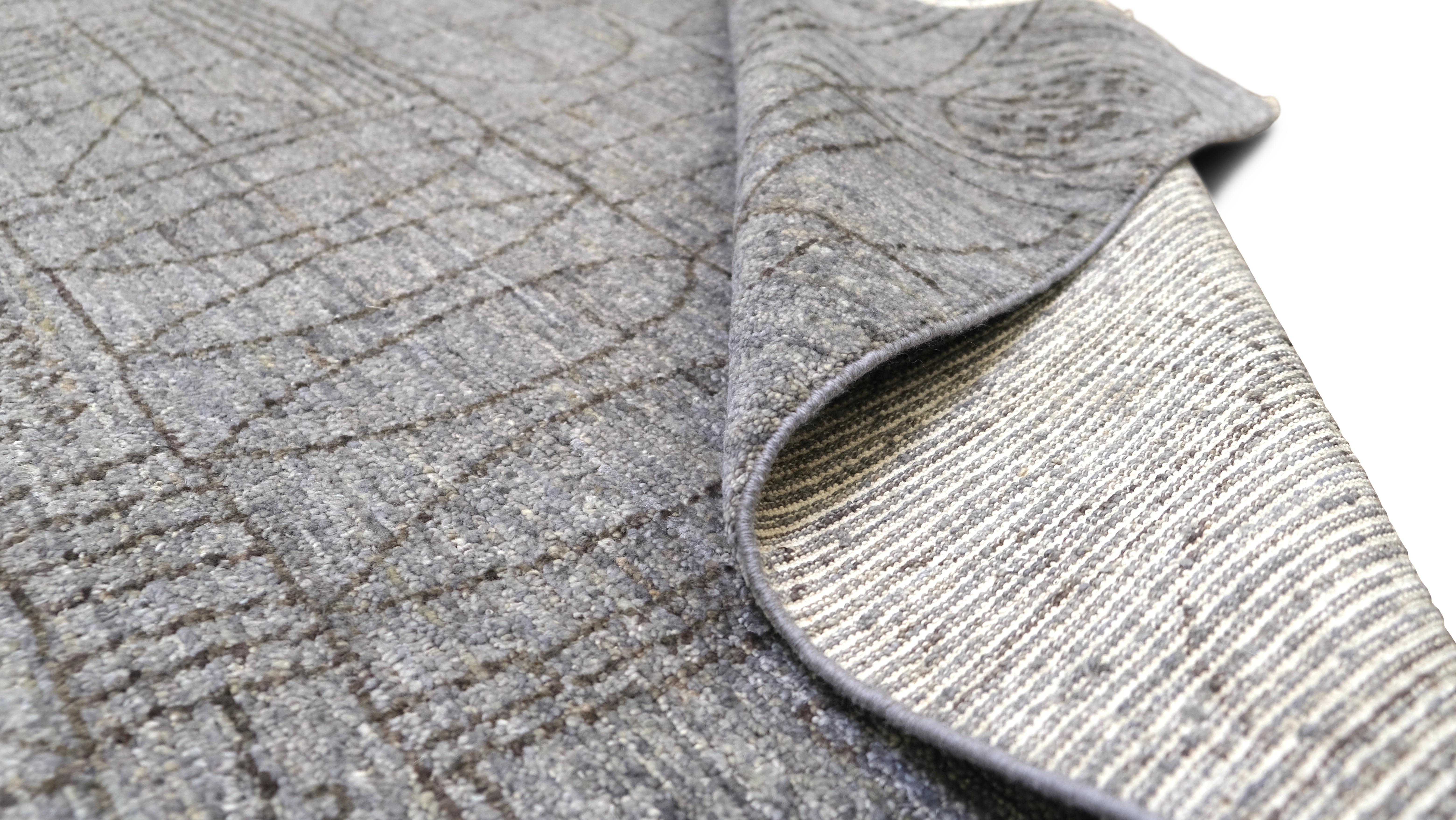  The rug features a sophisticated abstract geometric pattern with intricate linear detailing in soft, neutral grey tones. Its modern yet timeless design is perfect for elevating minimalist, contemporary, or transitional interiors.

Handcrafted by