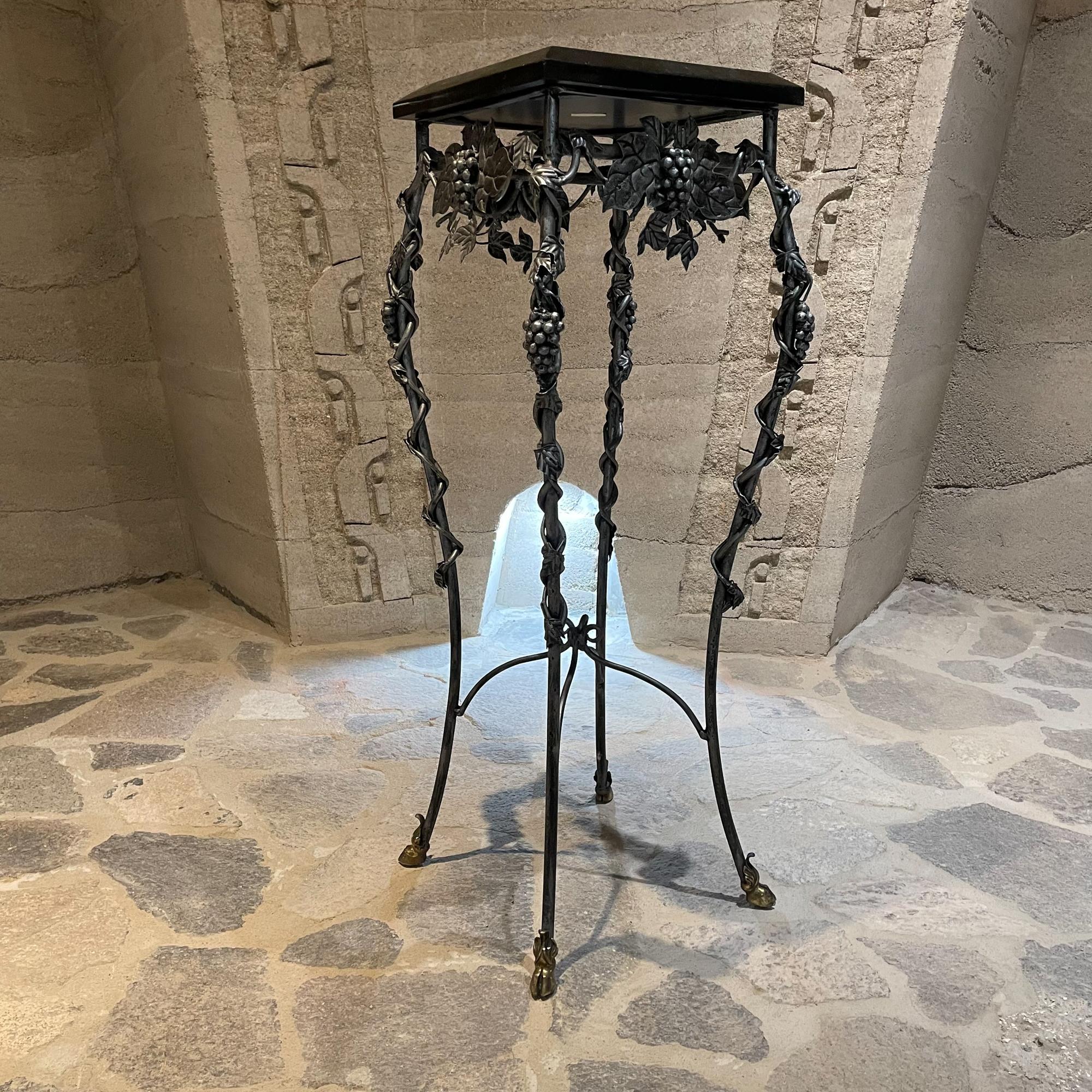 1980s Black Tessellated Stone Iron and Bronze Pedestal Stand or Entry Side Table 
Handmade in the Philippines designed by Maitland Smith LTD
Ideal to showcase sculpture.
Feet are accented with Bronze Sabots.
Maker label present.
42 H x 16 x 16