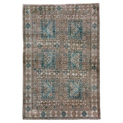 Intricate Symmetry: A Turkish Rug's Dance of Teal and Taupe in Geometric Splendo