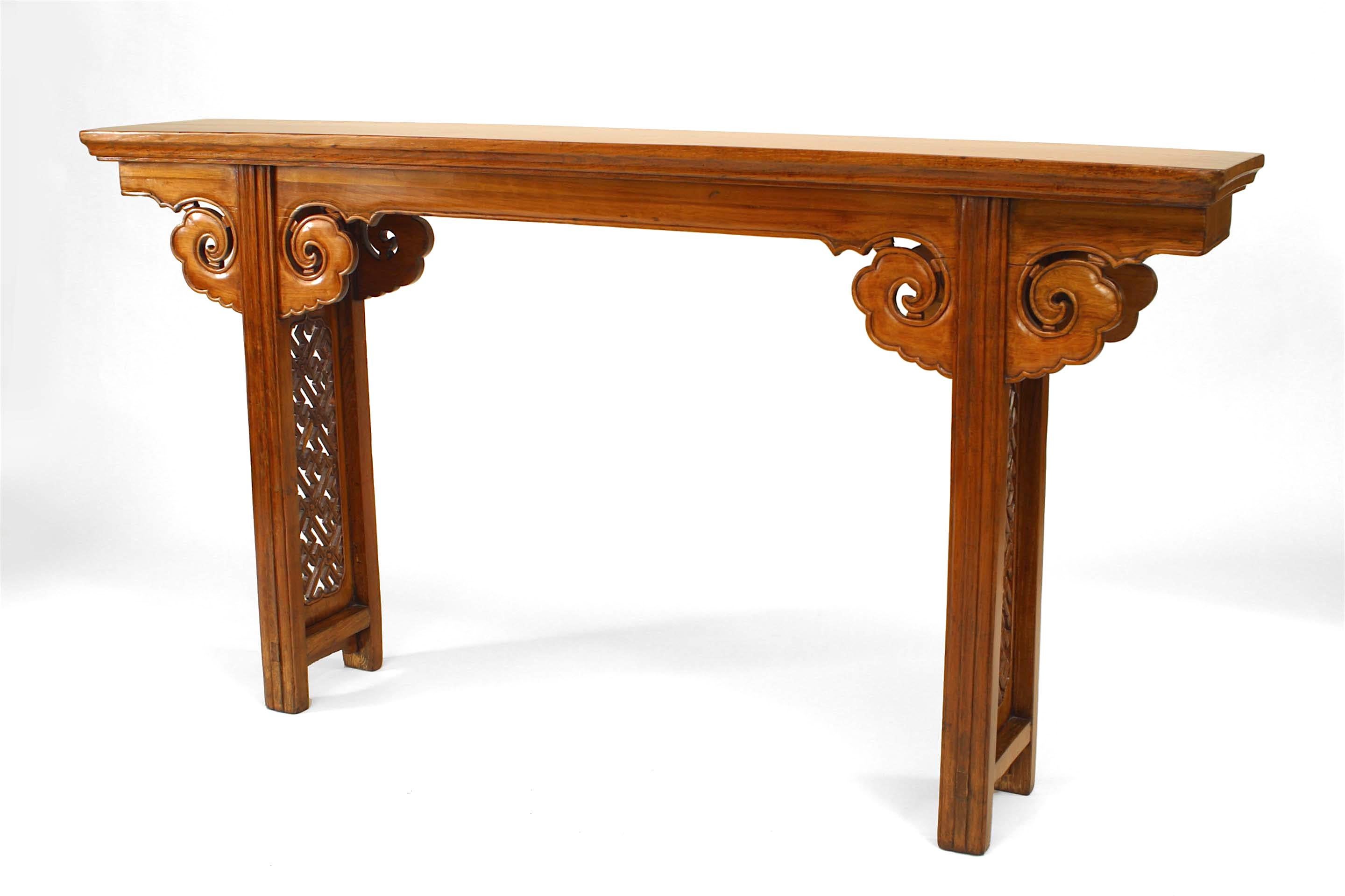 Chinese (18th Century) elmwood (yu-mu) narrow altar style console table with intrically carved geometric design end panels with fluted legs and cloud shaped scroll form spandrels on apron.
