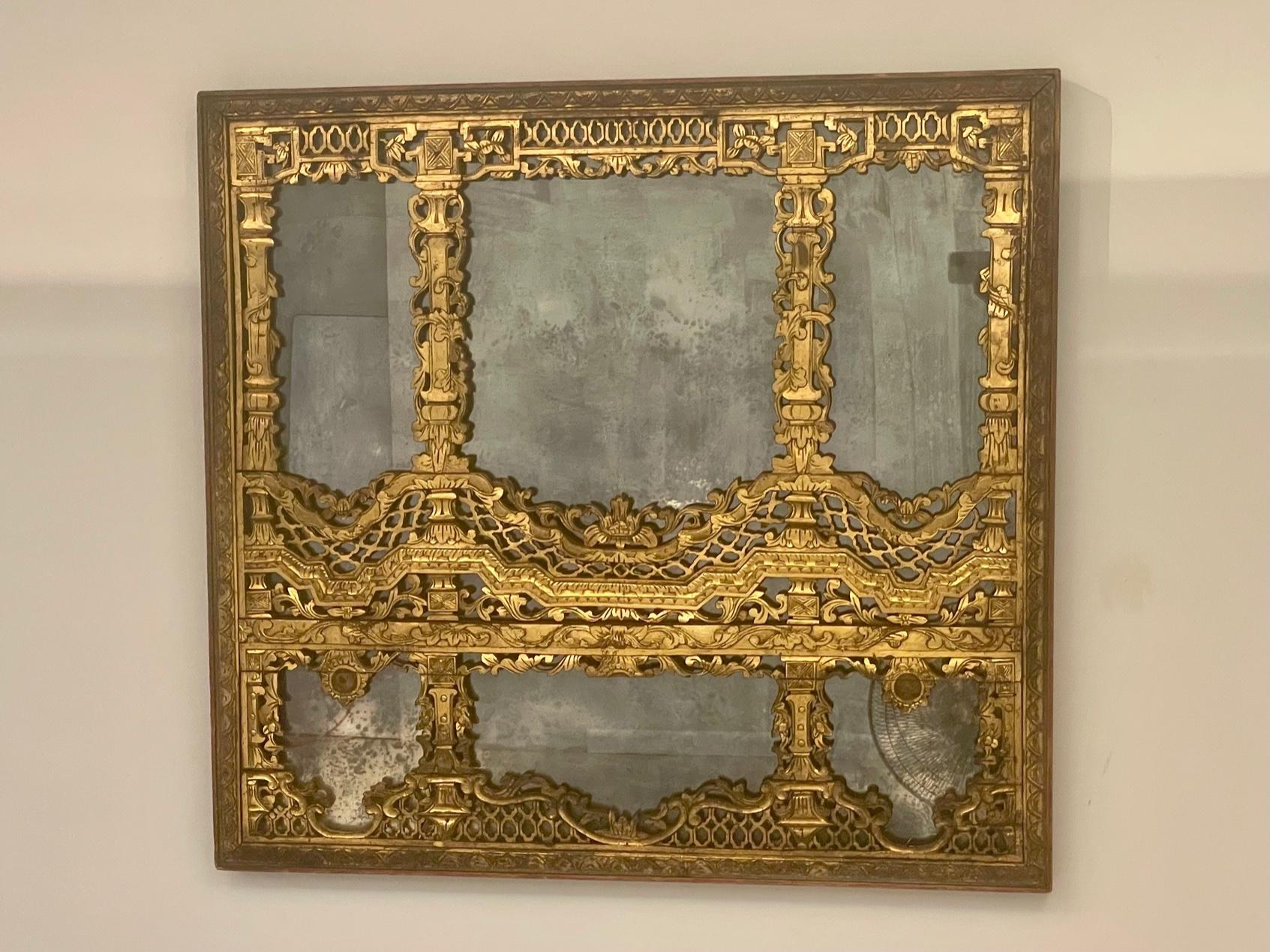 Magnificent intricately carved gilded Chinese mirror having aged mirror and superb ornate fretwork. Circa Late Qing Dynasty.