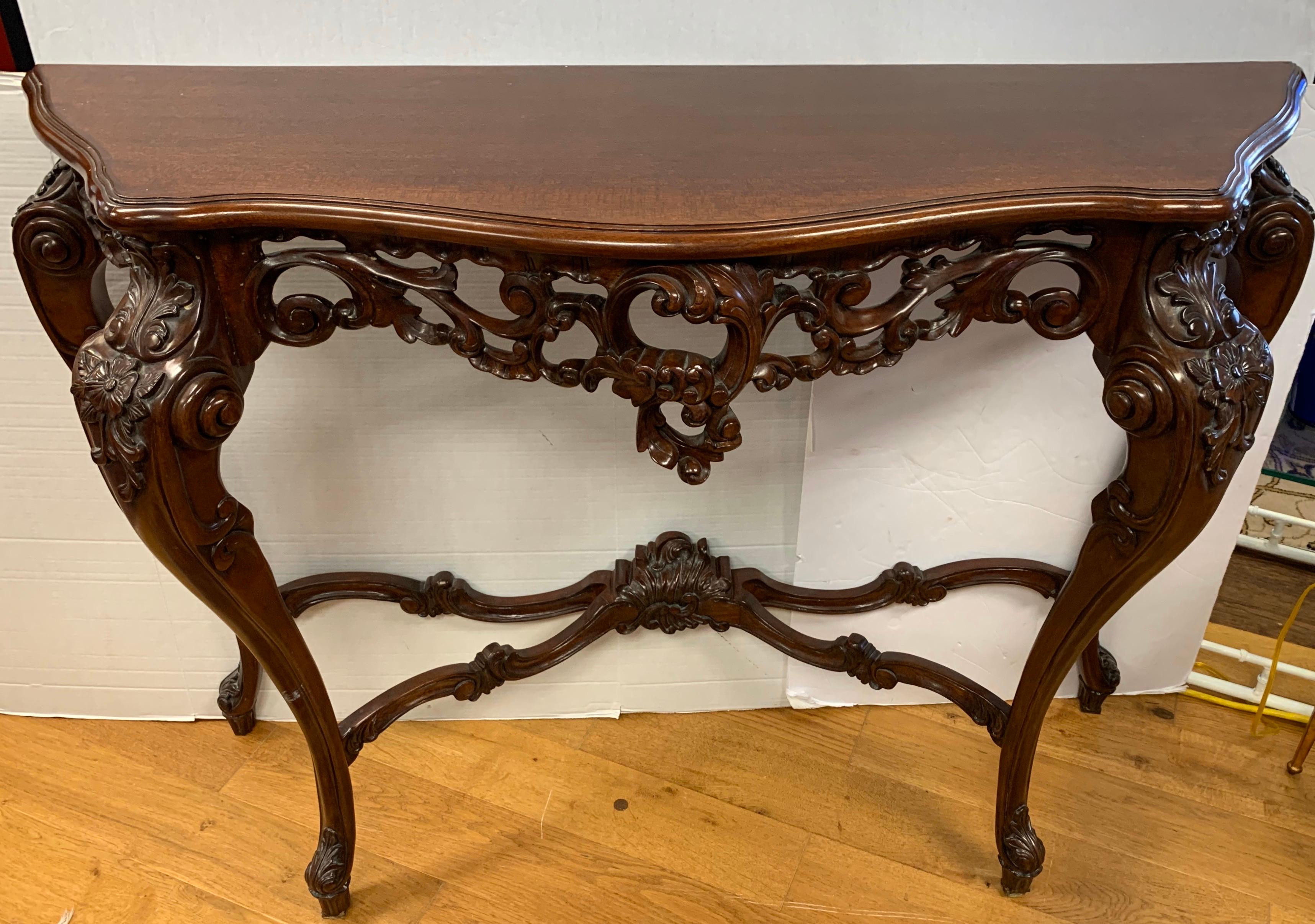 Stunning large French rococo walnut console table features intricate carvings which are stunning in their detail and craftsmanship. This antique piece was acquired by our client through Paramount Antiques in Manhattan. Stamped hallmark on back.