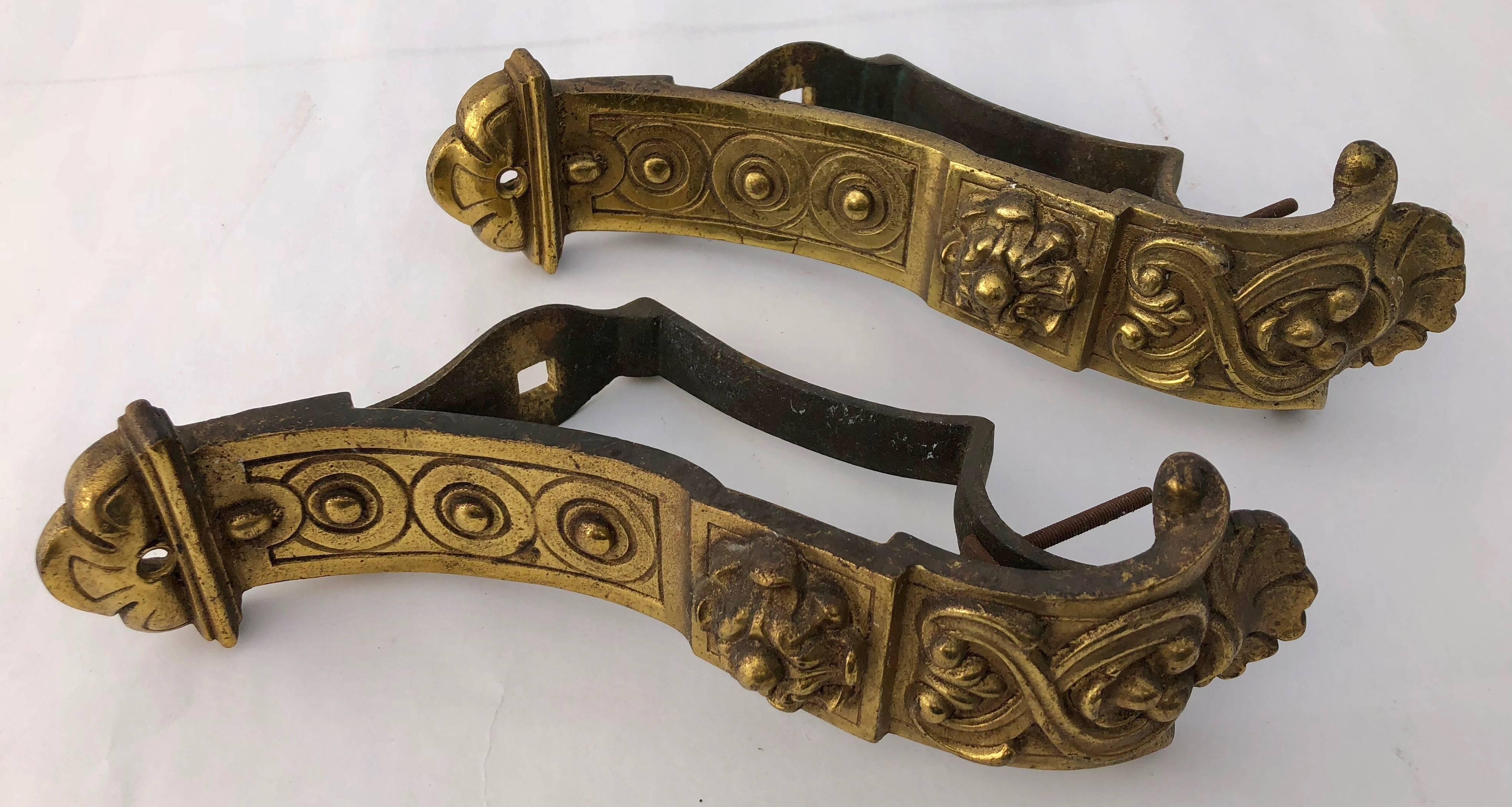 These are a set of two intricately detailed French brass, heavy curtain rod brackets from the 1800s. They come with their full rear mounting supports and have a gorgeous design of scrolls and rings. Adding these to any room would provide a stunning