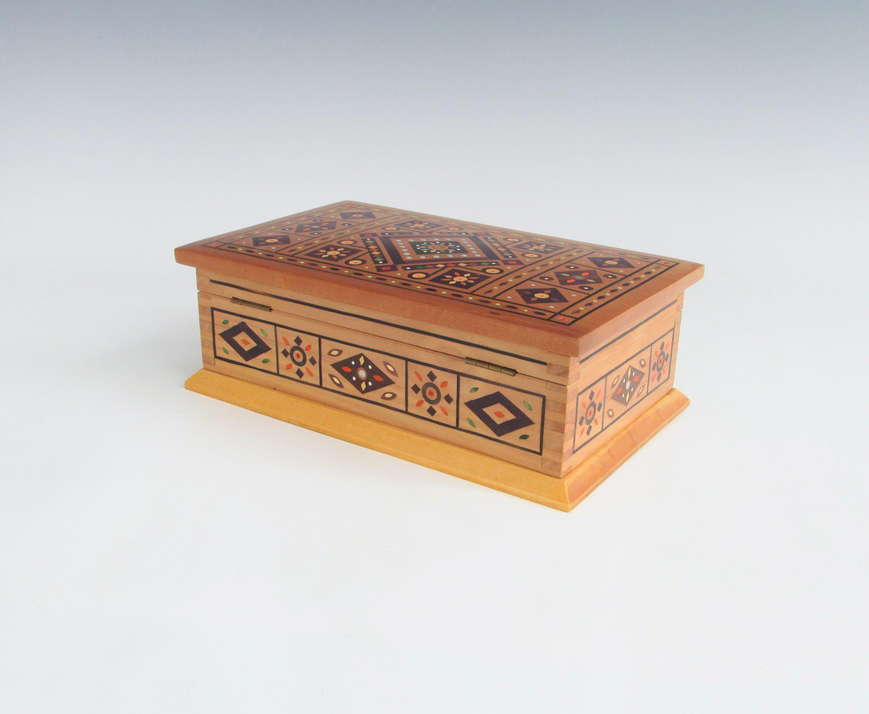 Very possibly polish in origin. Finely made and assembled lidded box. Dovetail corners and intricate inlay of exotic woods and beads.