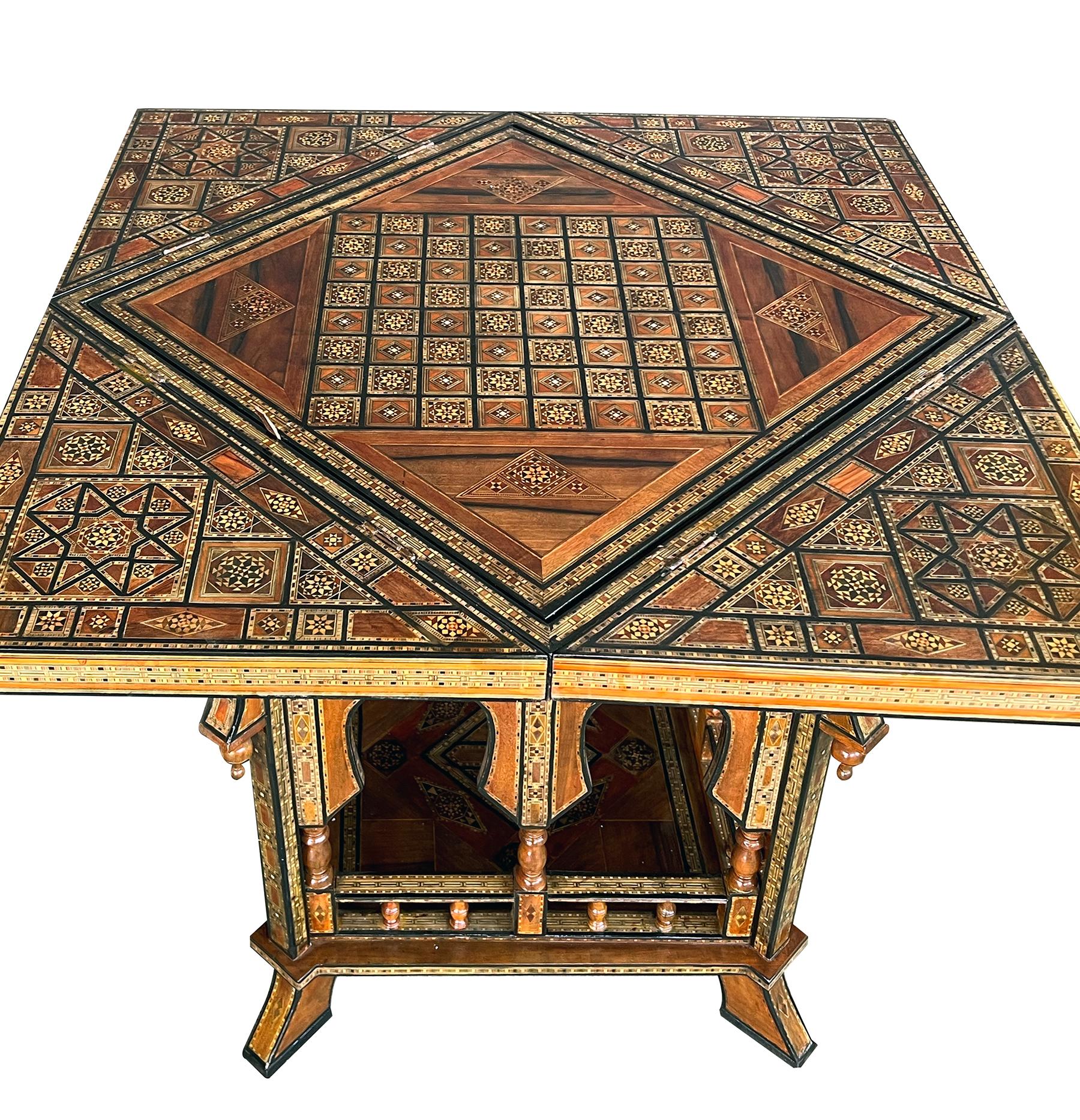 An impressively designed game table featuring a pivoting handkerchief top opening to reveal an intricately inlaid surface centering a removable center panel with game board and hand-tooled green leather surface on the flip side; resting on a body