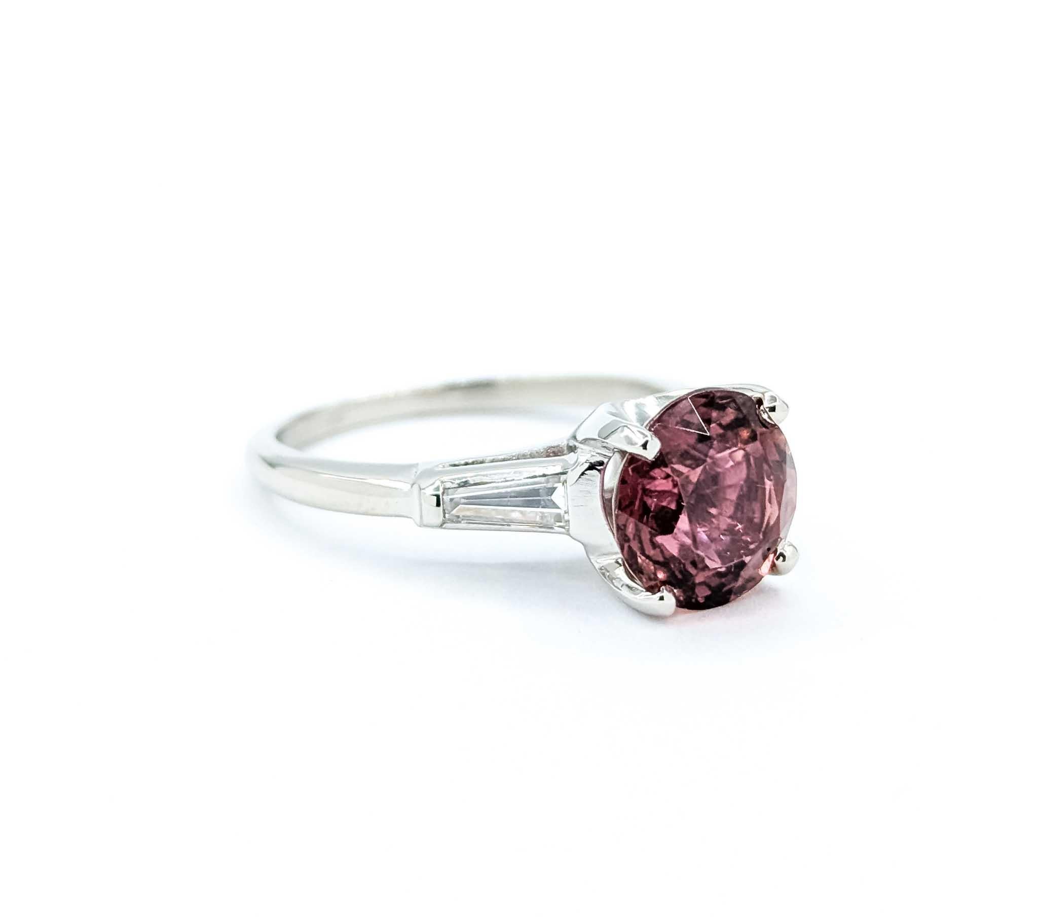 Introducing a stunning Tourmaline Ring expertly crafted in 900pt.

This unique piece features a .30ctw Diamond and a 2.91ct Reddish-Pink Tourmaline. The dazzling .30ctw are of VS clarity and boast a near colorless white hue. This ring is currently a