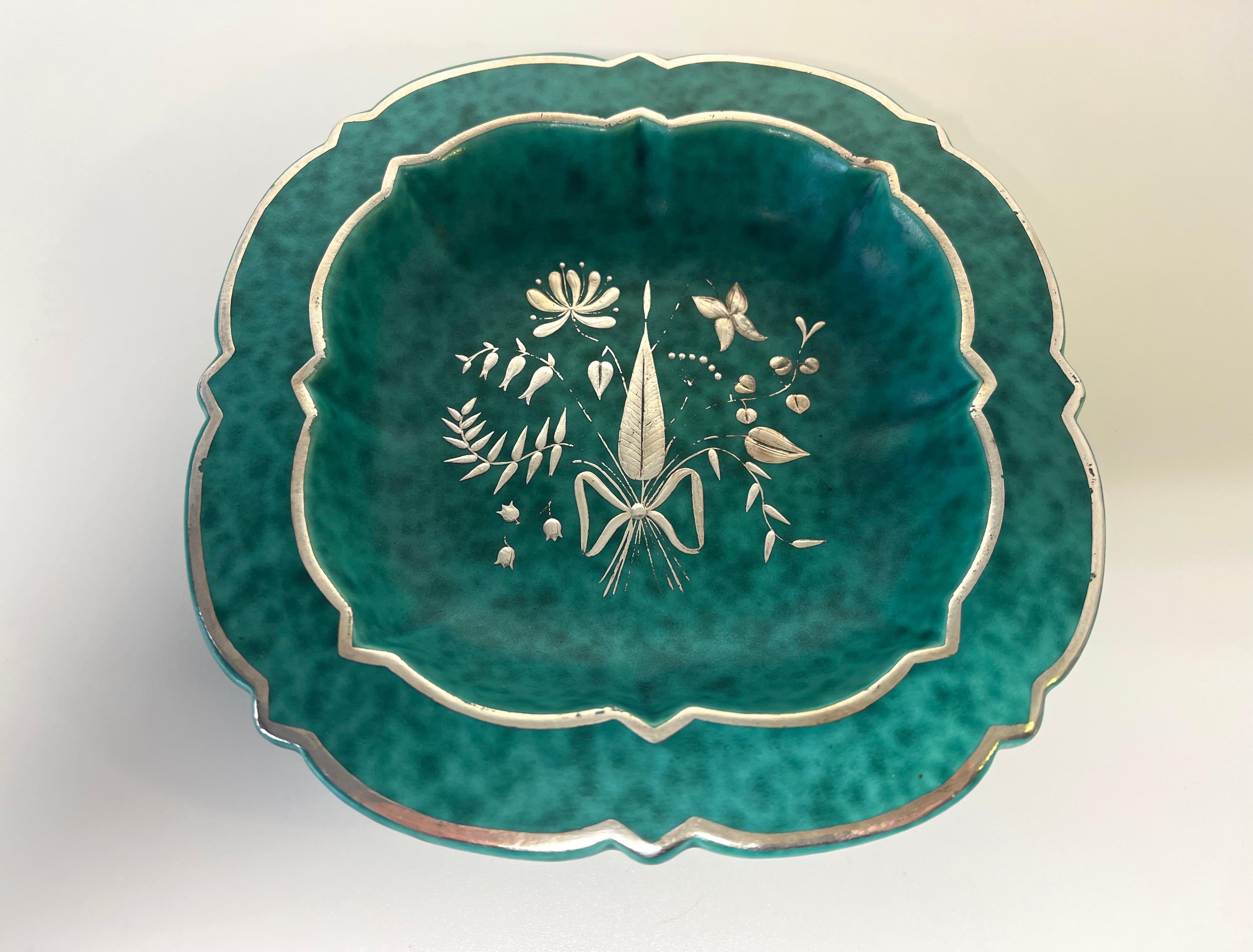 A beautiful square shaped mottled green stoneware dish with delicately applied silver flora decoration
Designed by Wilhelm Kage for the Argenta series for Gustavsberg, Sweden
Circa 1940
Signed to base Gustavsberg Argenta 1120 in silver