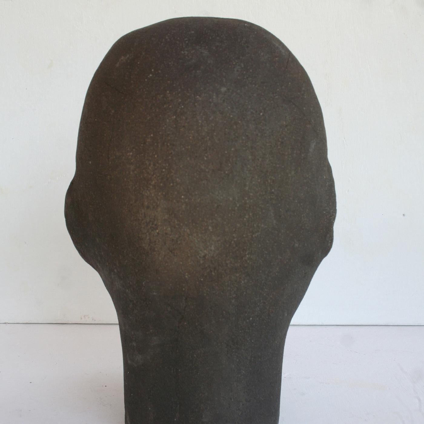 Contemporary yet Classic in its essence, this sculpture is an impressive piece that combines bold graphic elements and organic fluidity in perfect harmony. Entirely crafted by hand of ceramics, this piece features the silhouette of a head with