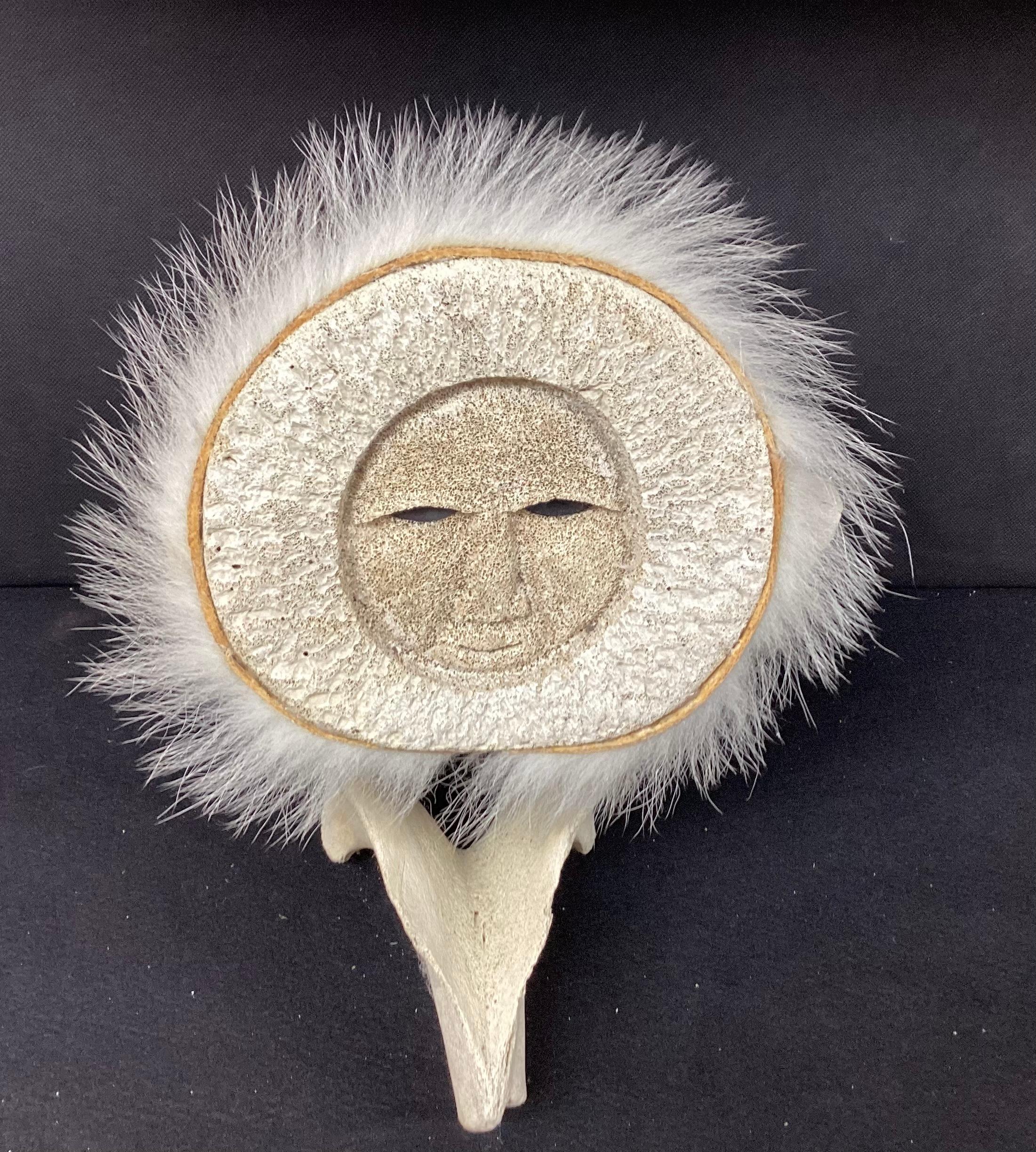 Inuit fossilized whale bone sculpture. Unique whale vertebrae with image of a native Eskimo hunter possibly with polar bear fur covering on head.