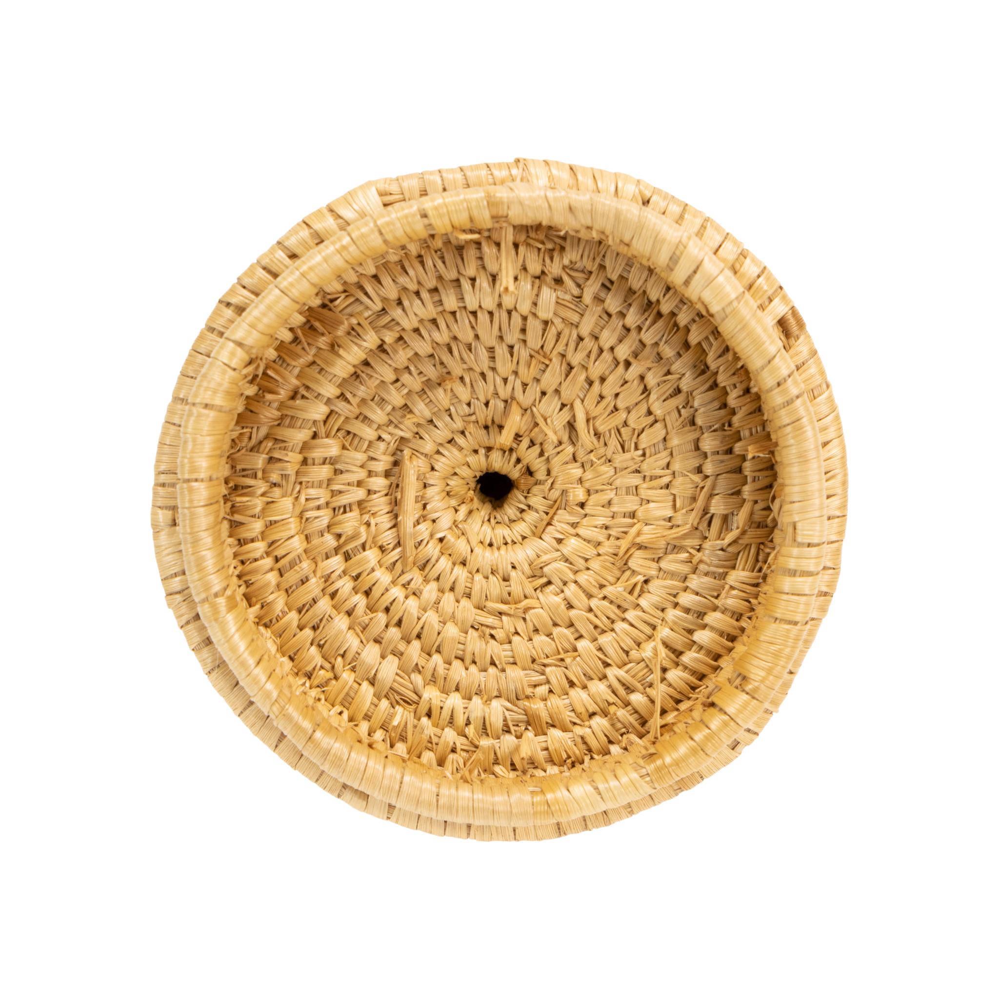 Alaskan Inuit lidded basket of fine weave with top knot. Tapered from bottom to shoulder and then to top. Featuring geometric designs running diagonally up the piece in colors of red and blue. Great for display or continued use. Mid 20th century.