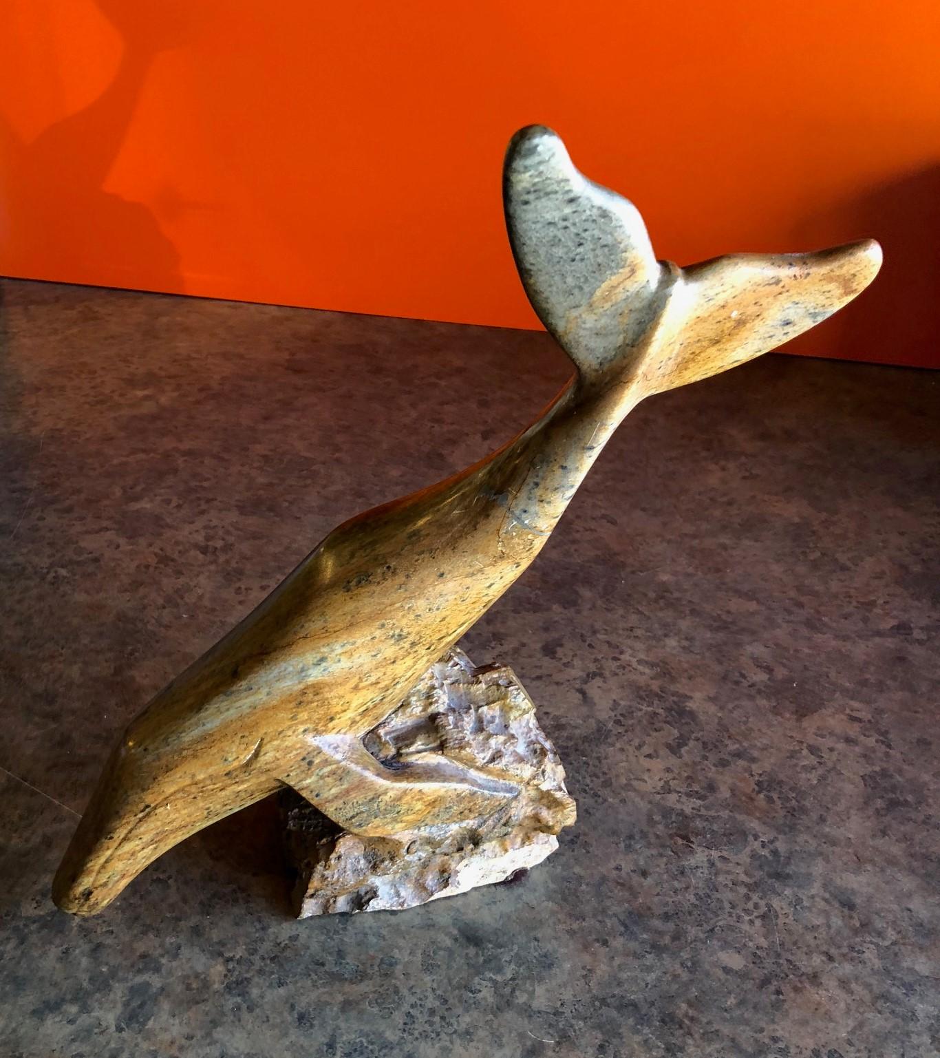 Gorgeous Inuit soapstone whale sculpture, circa 1984. The piece is signed and has wonderful color and detail. Stunning piece for any room!