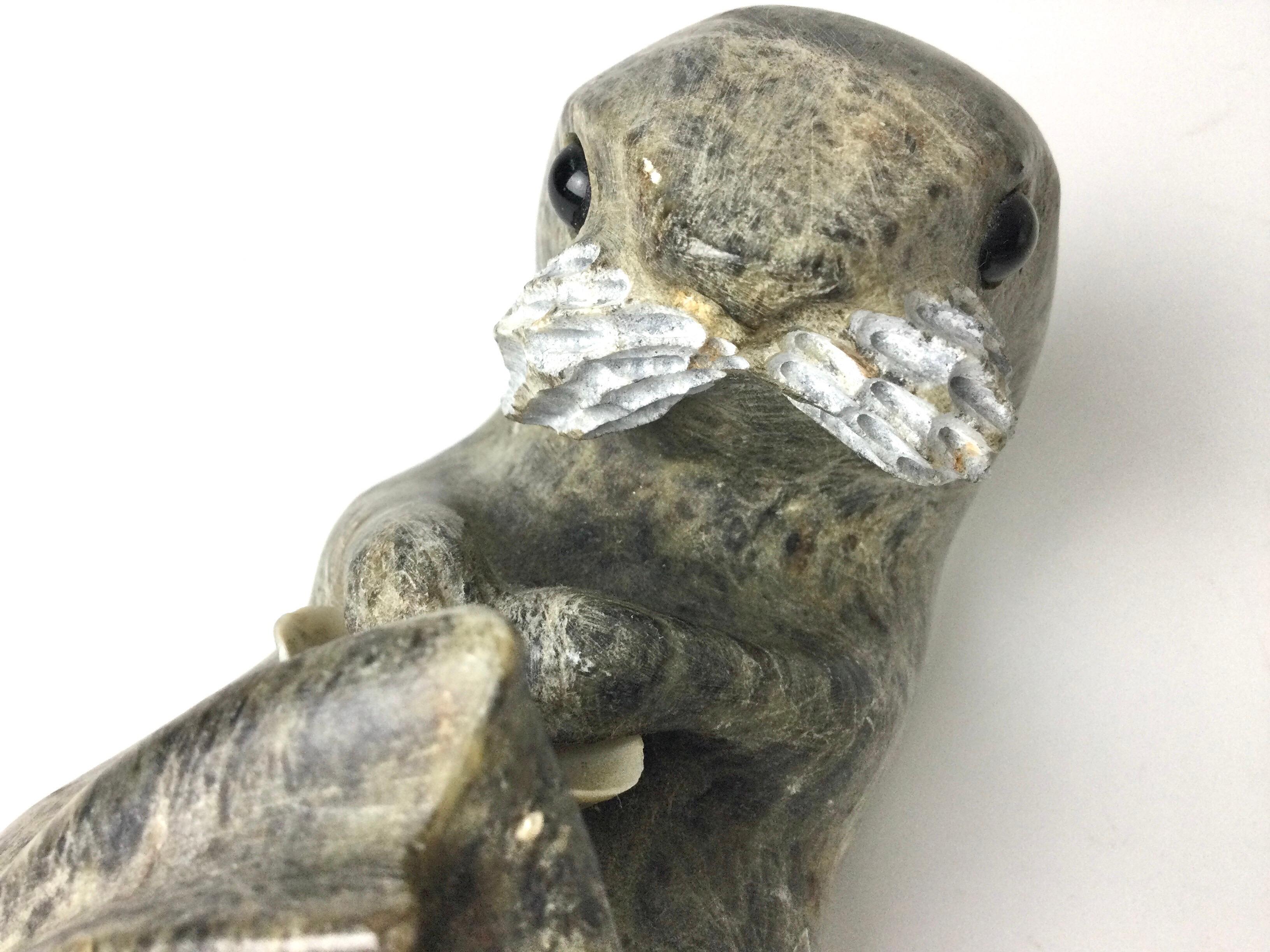 Hand-Carved Inuit Stone Carving of a Otter with Shell Signed Drake For Sale