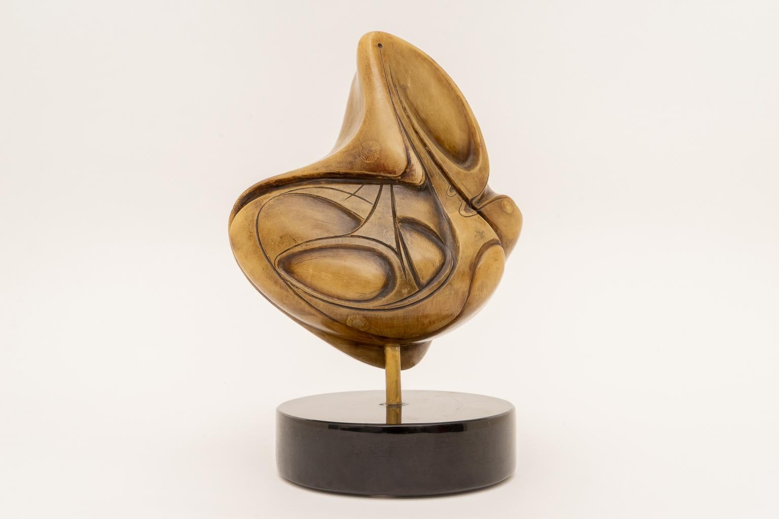 This beautiful sculpture has the overtones of Inuit pieces, but we cannot guarantee that the piece is. The stone is dense and seems to have had a darker color rubbed into it. The base seems to be made of either marble or granite.

Note: See Image