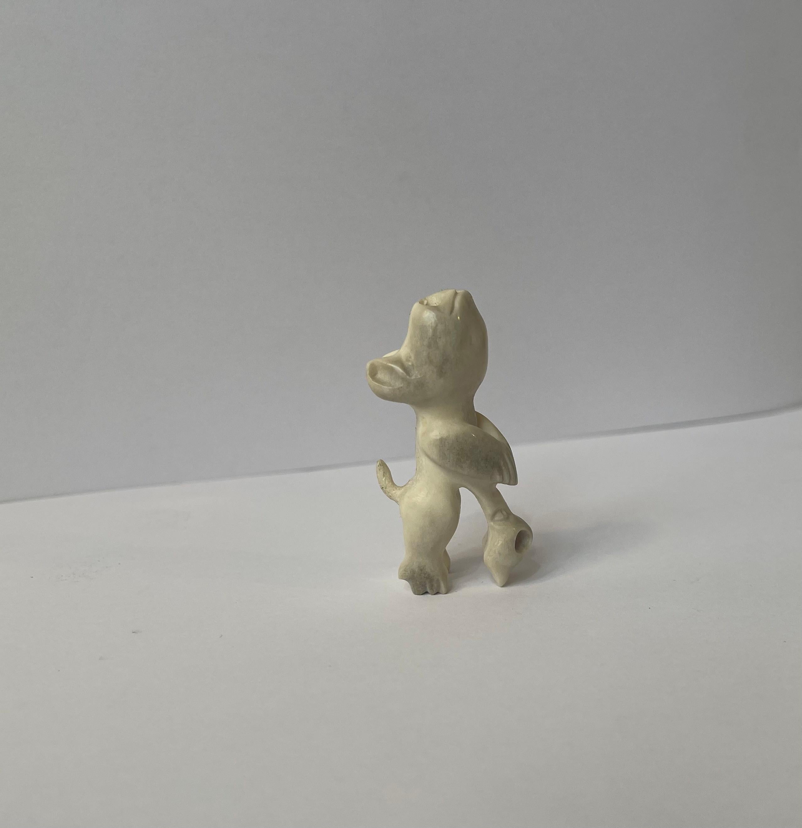 Unusual miniature Inuit Tupilak in hand-carved bone or tooth (5.2x2x3.5 cm). It depicts a cat-like mythological being/spirit. It has no signature or markings but in was brought home from Greenland to Denmark by a tradesman circa 1930-35. Wellkept