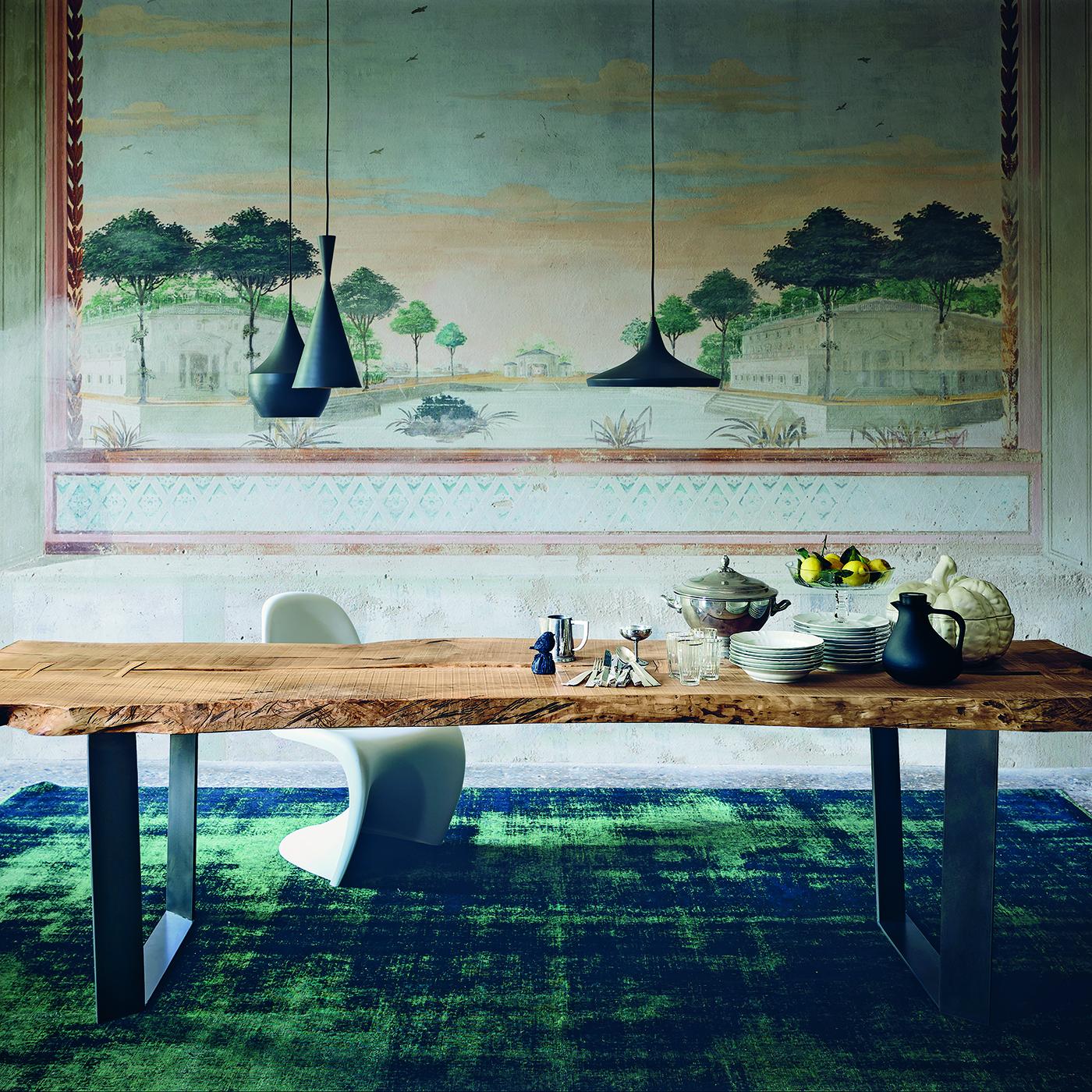 This beautiful dining table boasts a secular olive wood top. Unfinished edges with burnt detailing bring out its natural warmth, beauty and imperfections, telling the story of the tree from which it is made. Handcrafted using dovetail joints, the