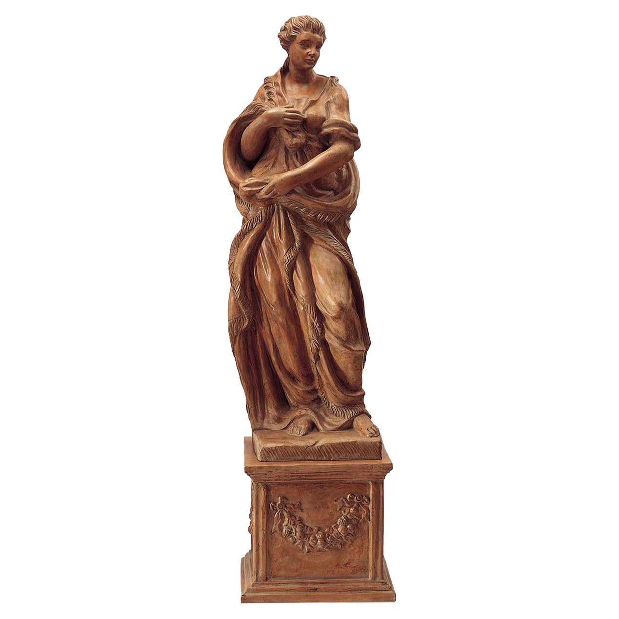 An exquisite celebration of Florentine Renaissance, this stupendous sculpture embodies the glorious allegros of Winter. Depicting an elegant lady protecting herself with heavy clothes from the cold weather, it is superbly handcrafted of ceramic
