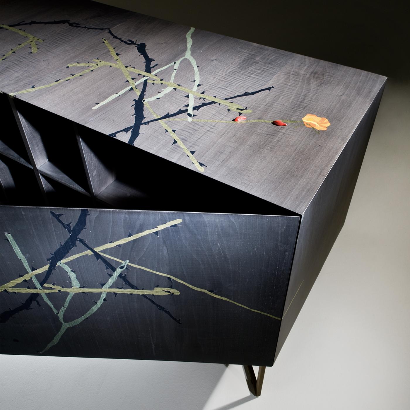 Two linear geometric legs crafted in brass support this long rectangular wooden sideboard. This work of functional art is one of only 21 specimens in this limited series. An abstract, multicolored pattern adorns this piece on all sides, top