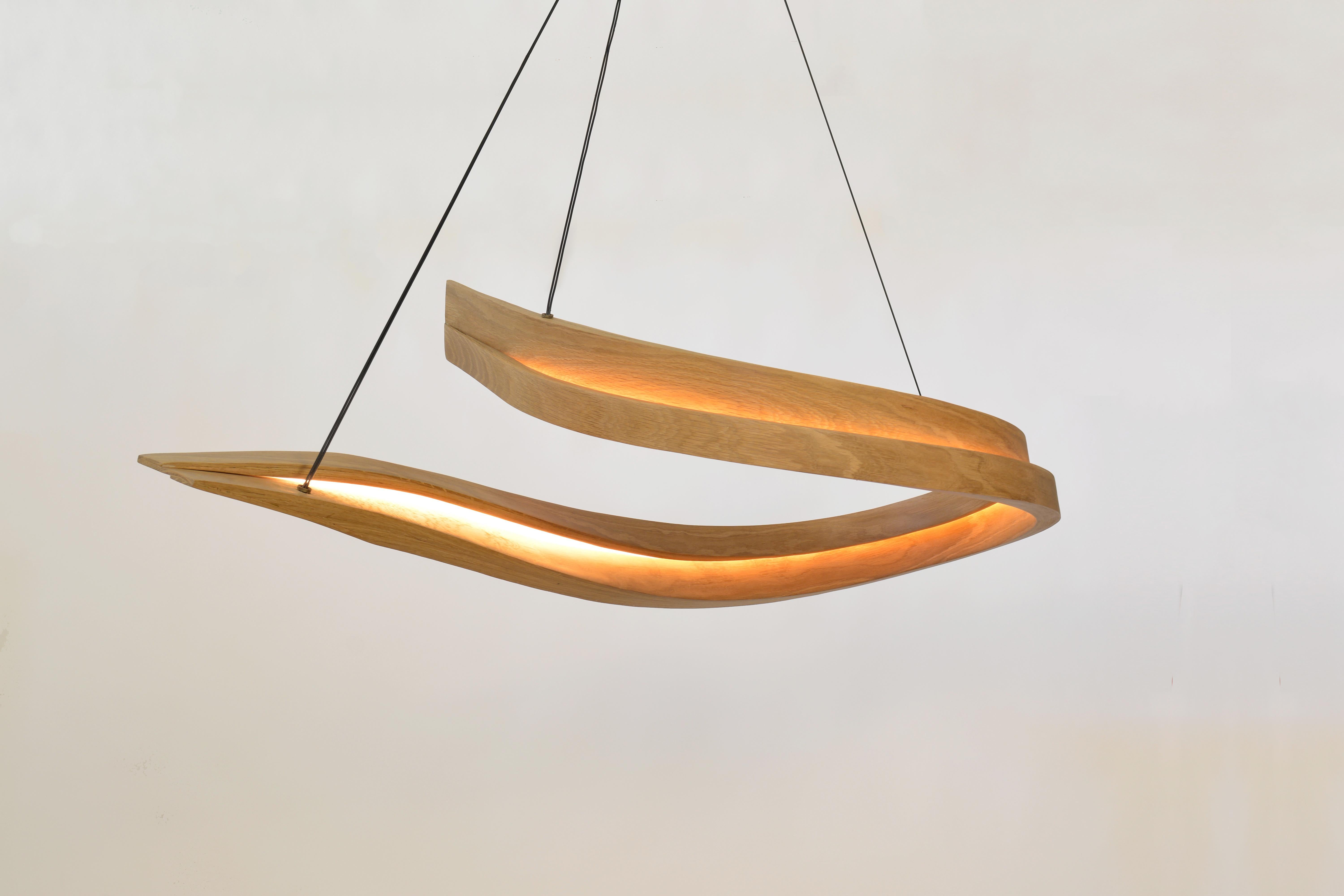 The Invert is a dual light-faced freeform pendant formed from wood and high-output dimmable LED. Opposite facing light channels on each major face create a balanced glow that compliments the freeform curve to create an even distribution of light