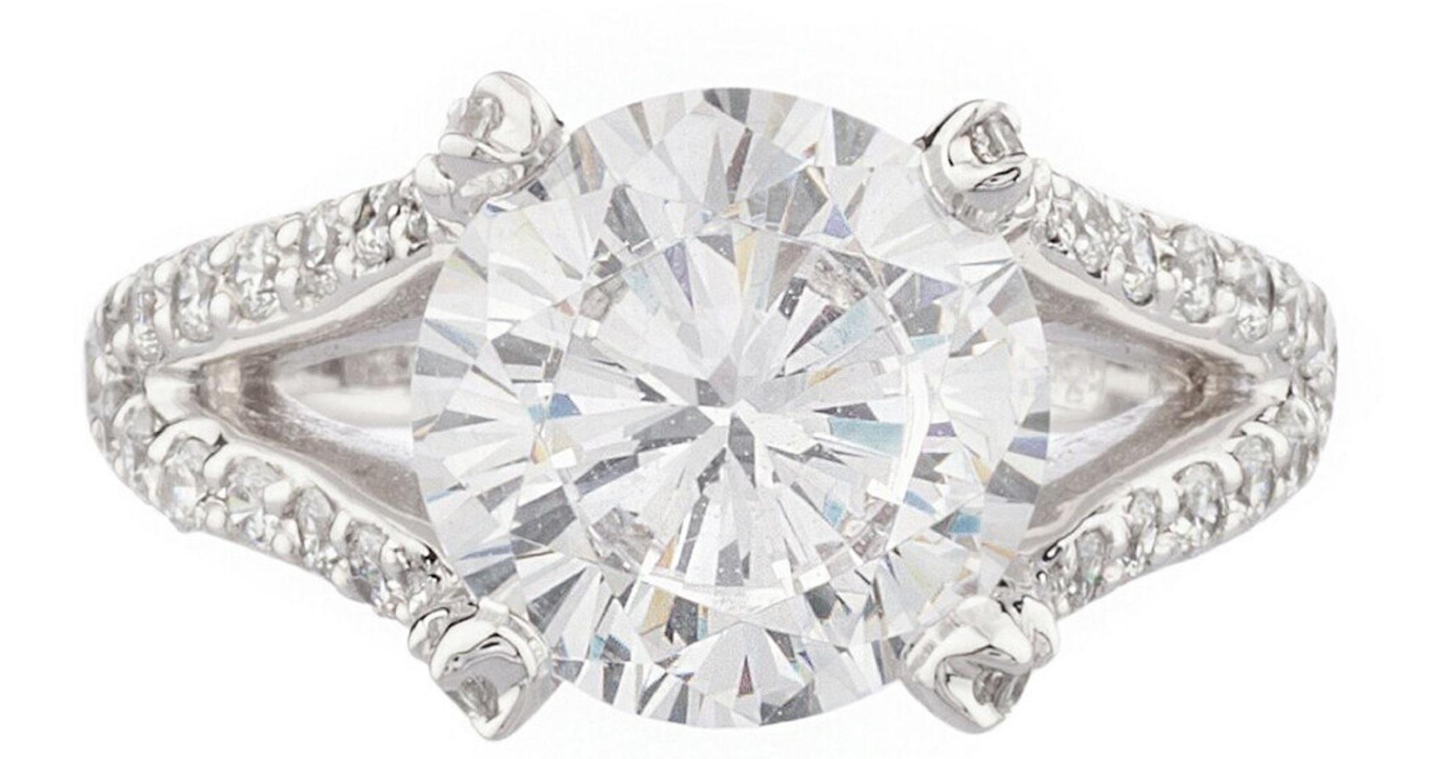 This exquisite GIA 4 Carat Round Brilliant Cut Diamond has a beautiful open shank pave of natural brilliant cut diamonds with a total weight of 1 carats
