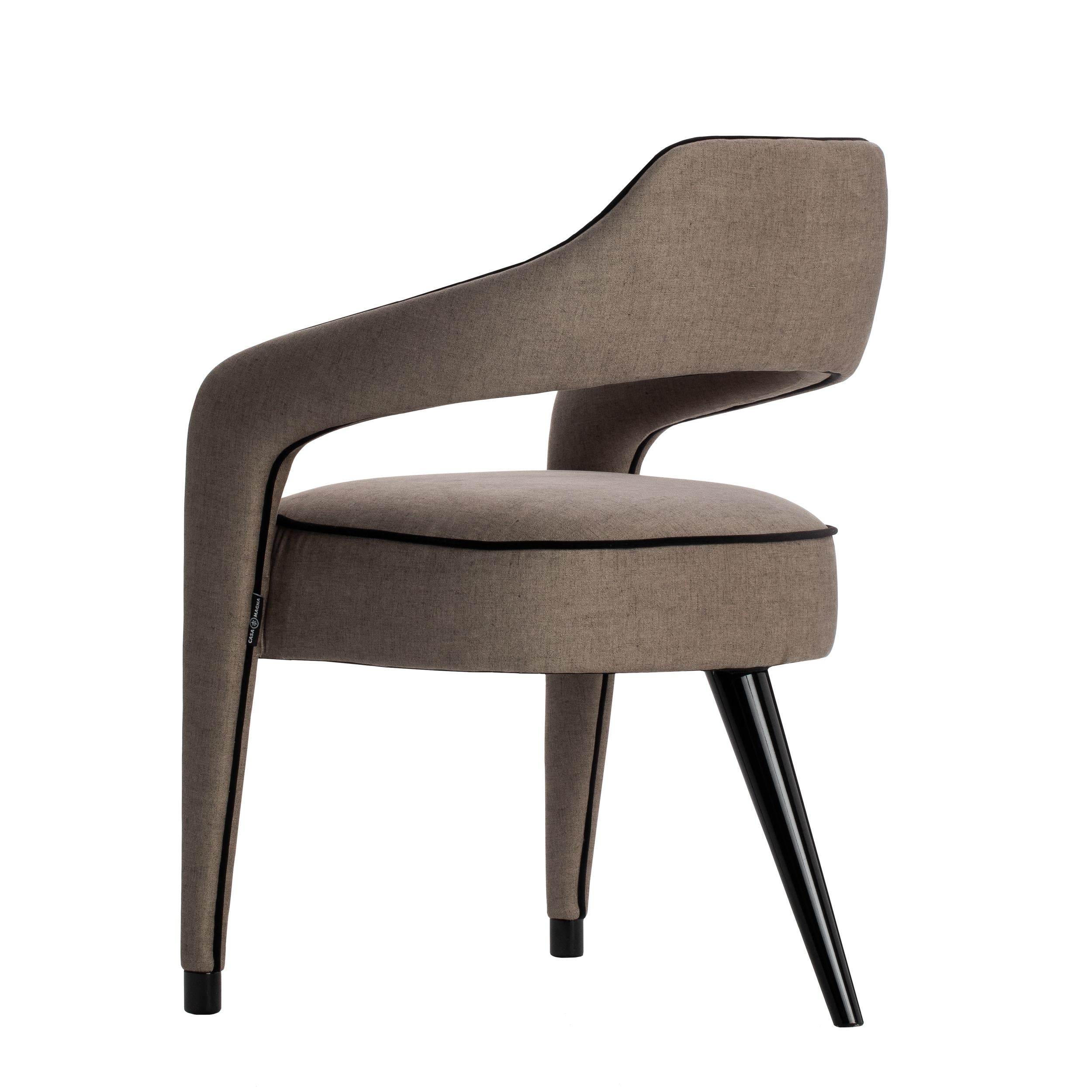 The INVICTA dining chair is a unique piece, and the impressive design with just one leg in the back, in solid wood, will make the dining room a sophisticated space.‎ Upholstered in fabric, with contrasting piping that run from the front legs along
