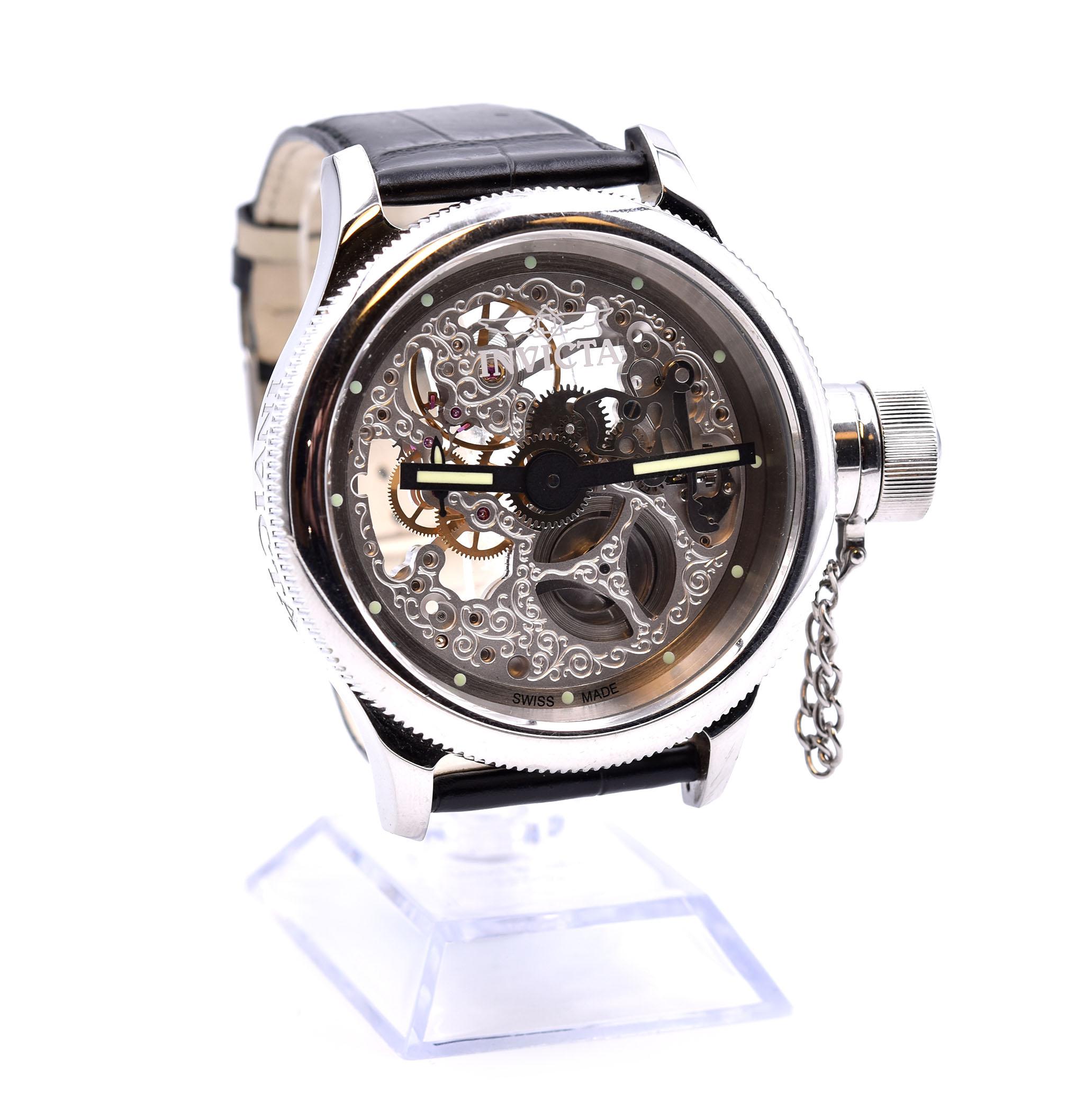 Movement: mechanical 
Function: hours, minutes
Case: 51.5mm stainless steel case, flame fusion crystal, exhibition case back
Dial: silver skeleton dial with luminescent hour markers and hands
Band: black alligator print on leather strap, tang