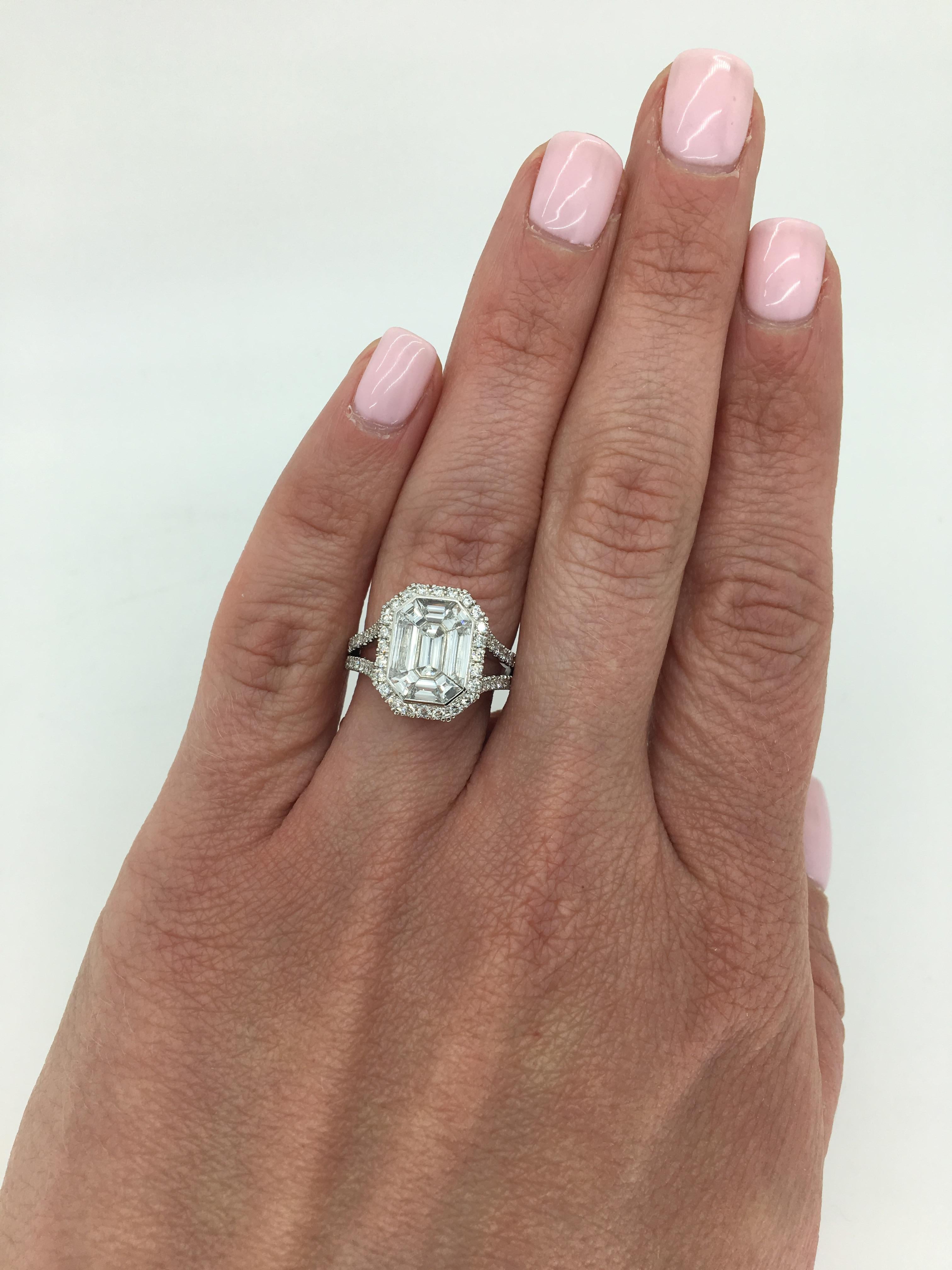Invisible set Emerald shaped split shank halo diamond engagement ring crafted in 14K white gold.

***The center diamonds are equivalent to an approximately 3.00CT Emerald Cut***
Diamond Carat Weight: Approximately 2.00CTW
Diamond Cut: Trapezoid Cut,