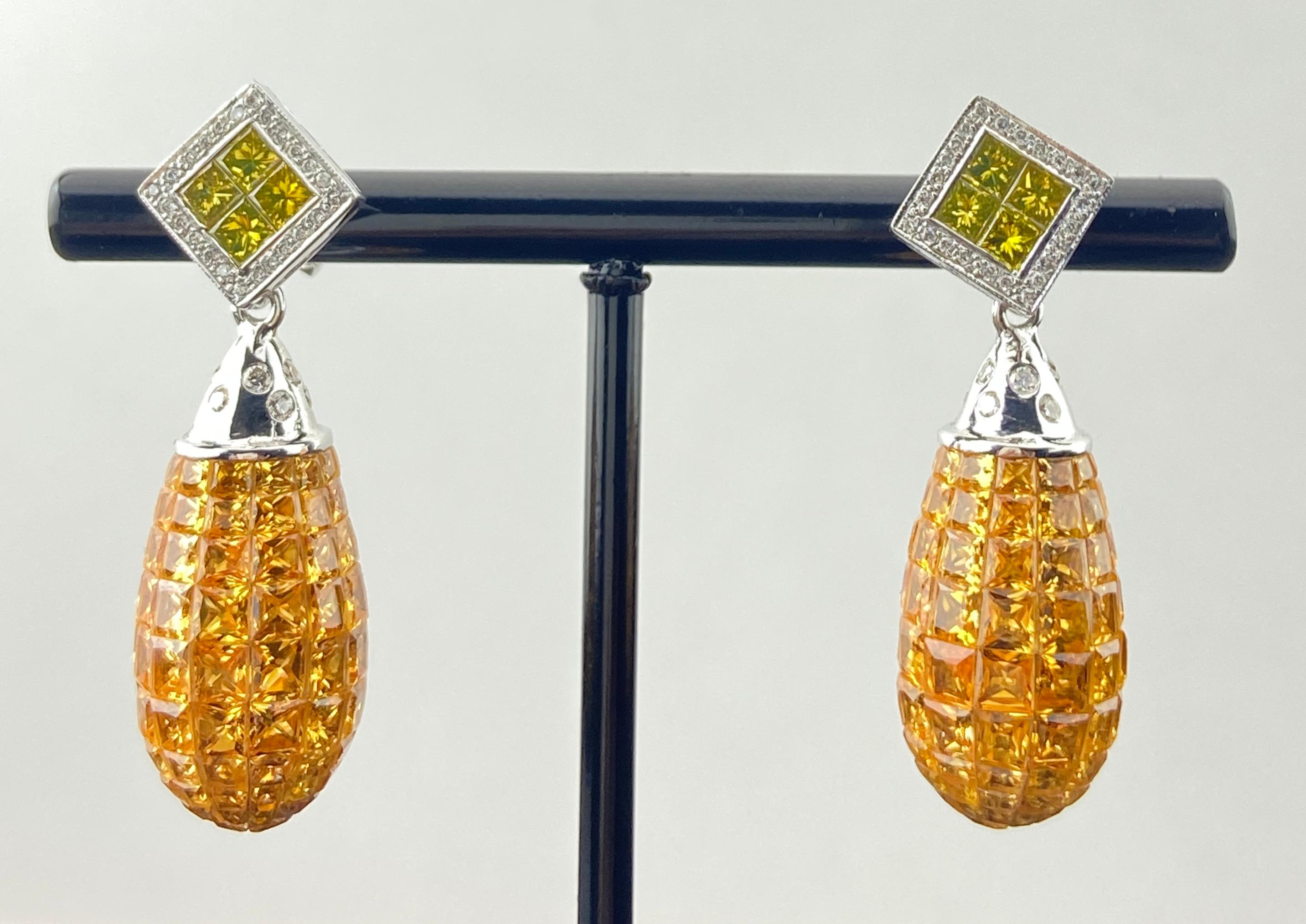 These luminous earrings exude warmth and sophistication, crafted in 18K white gold and adorned with 30.35 carats of invisibly set yellow sapphires. Their golden glow is beautifully offset by a geometric top featuring a vivid yellow princess-cut