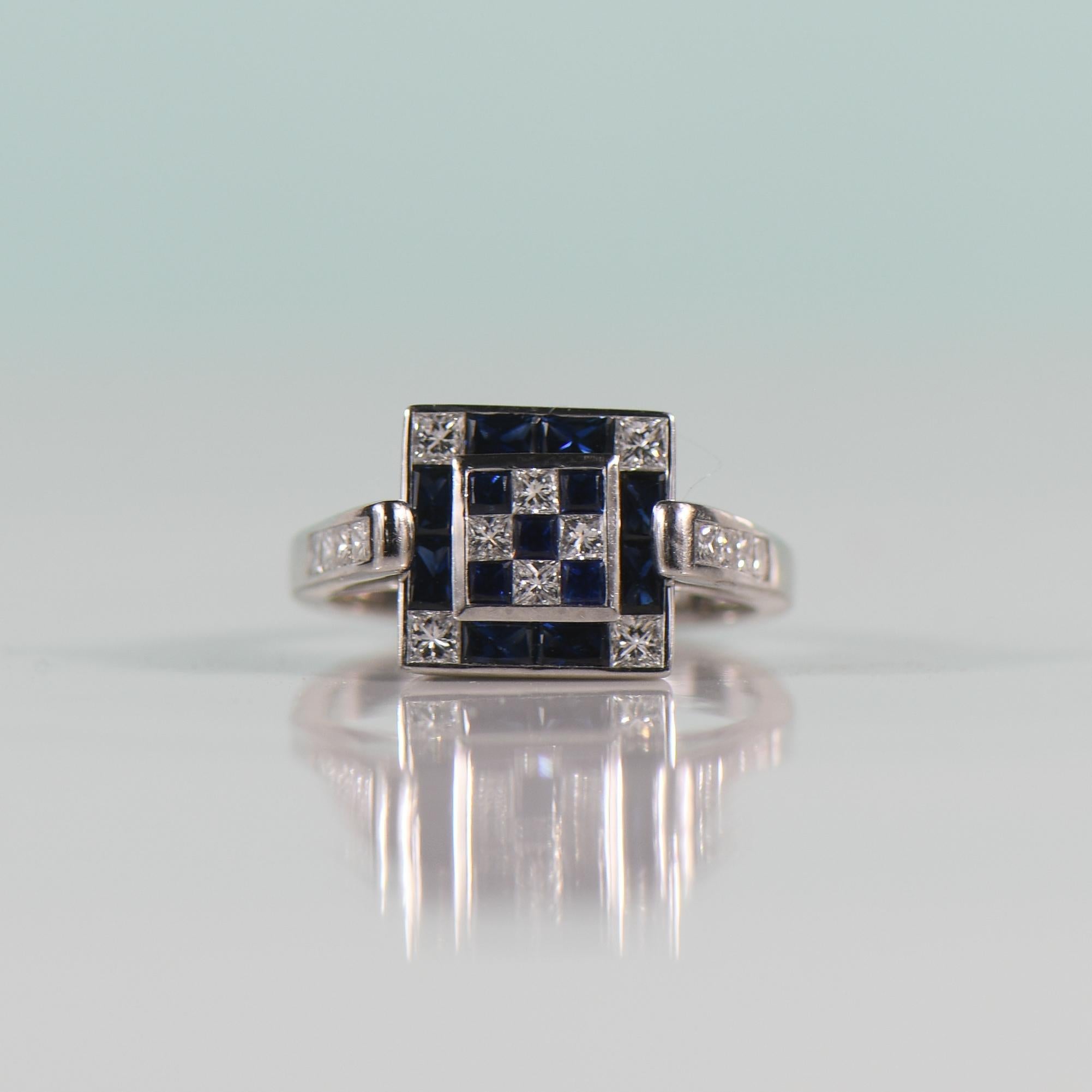 Indulge in modern elegance with this cathedral shoulder diamond and sapphire ring, a captivating union of sophistication and contemporary design. Crafted in luxurious 18k white gold, the invisible setting seamlessly melds princess cut sapphires and