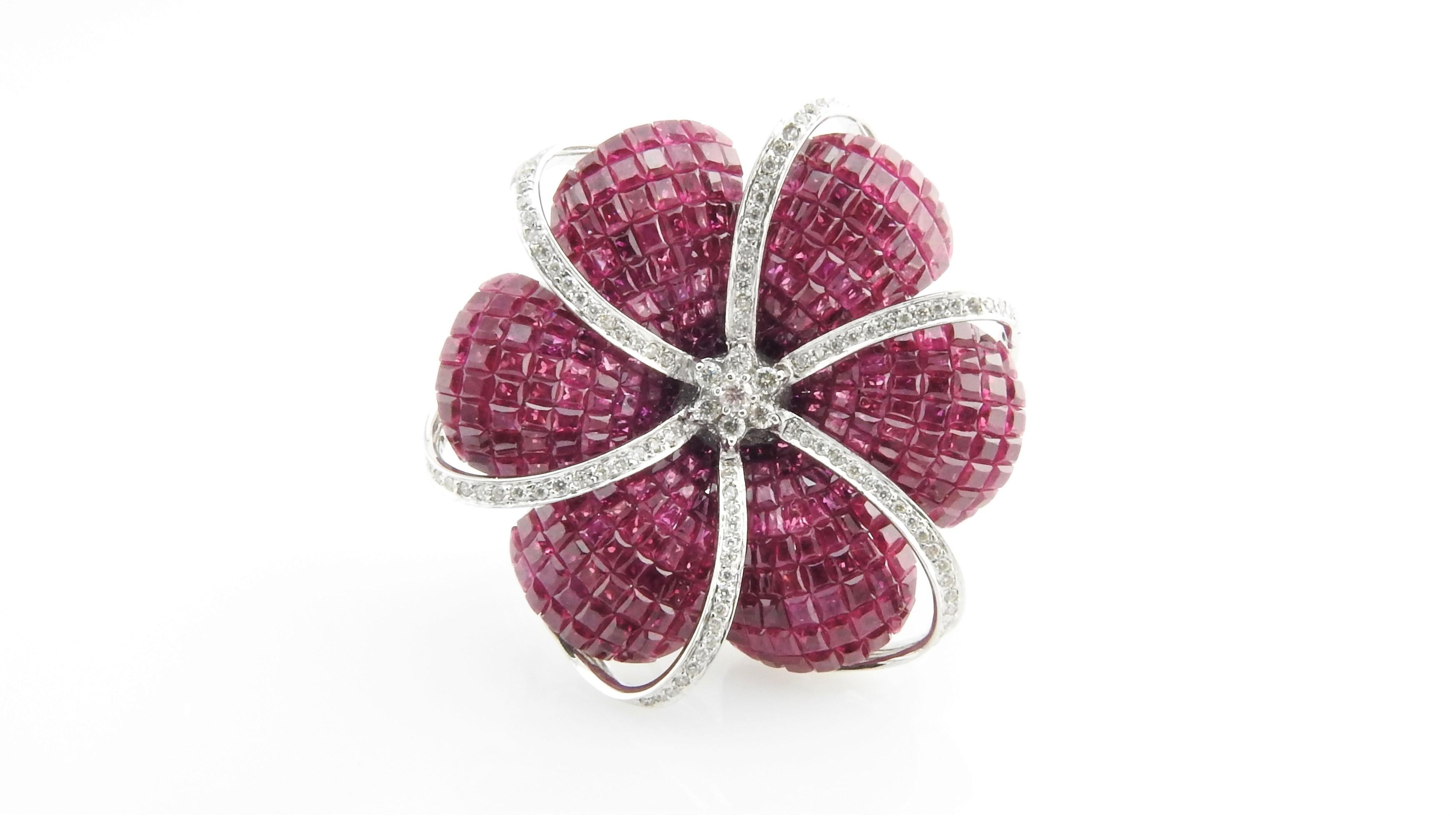 Invisible Set Genuine Ruby and Diamond Flower Brooch / Pendant

This lovely floral piece can be worn as a brooch or a pendant and is set in 18K White Gold.

It is invisible set with 324 genuine red rubies.

102 round brilliant diamonds total approx.