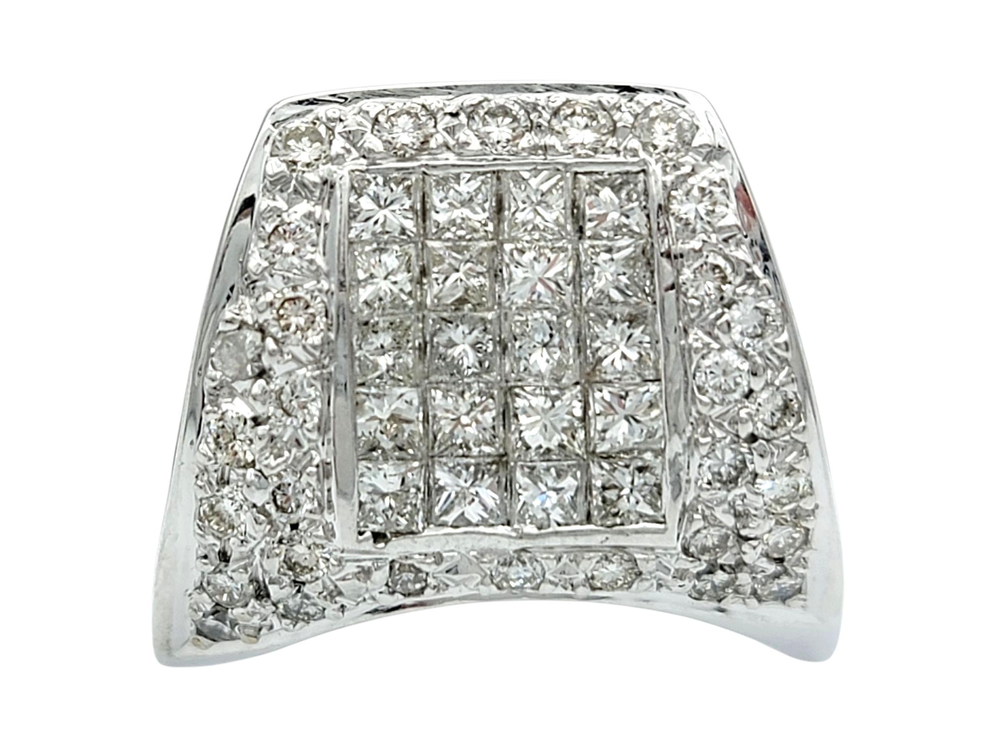 Ring Size: 9

This striking diamond ring features a bold and modern design, showcasing a dynamic arrangement of round and princess-cut diamonds. The upper face of the ring glistens with geometric precision, as the princess-cut stones form a clean,