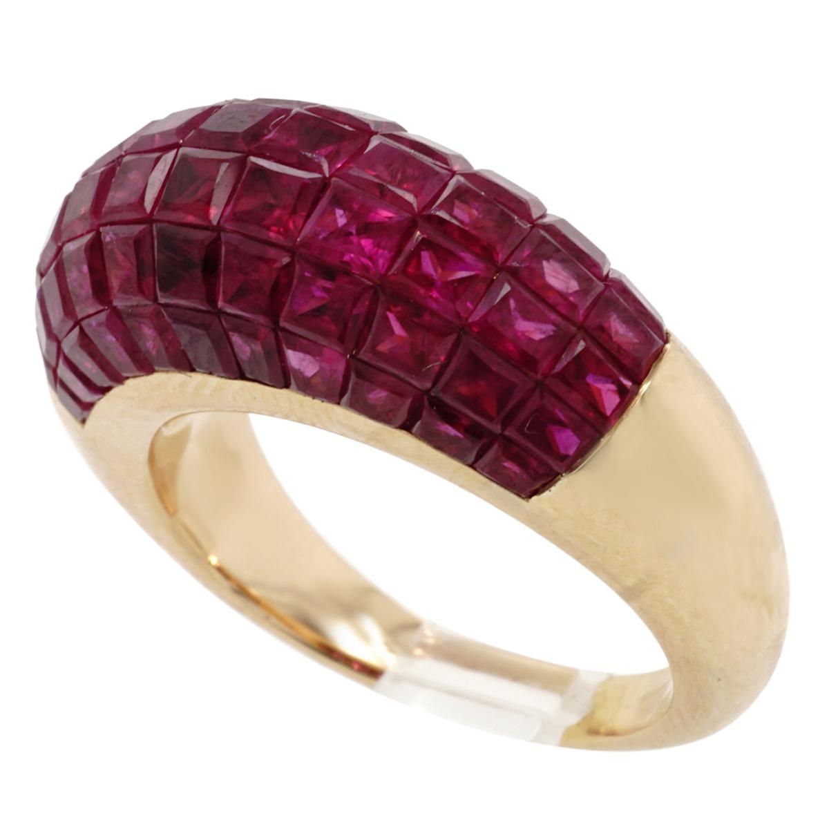 Crafted in 18 karat yellow gold featuring invisibly set calibrated rubies.   Ring size 5,  weighs 10.4 gr./6.7 dwt.   Ring is in excellent condition.  Rubies are of fine quality.

Ruby:  Estimated weight 3.00 carats