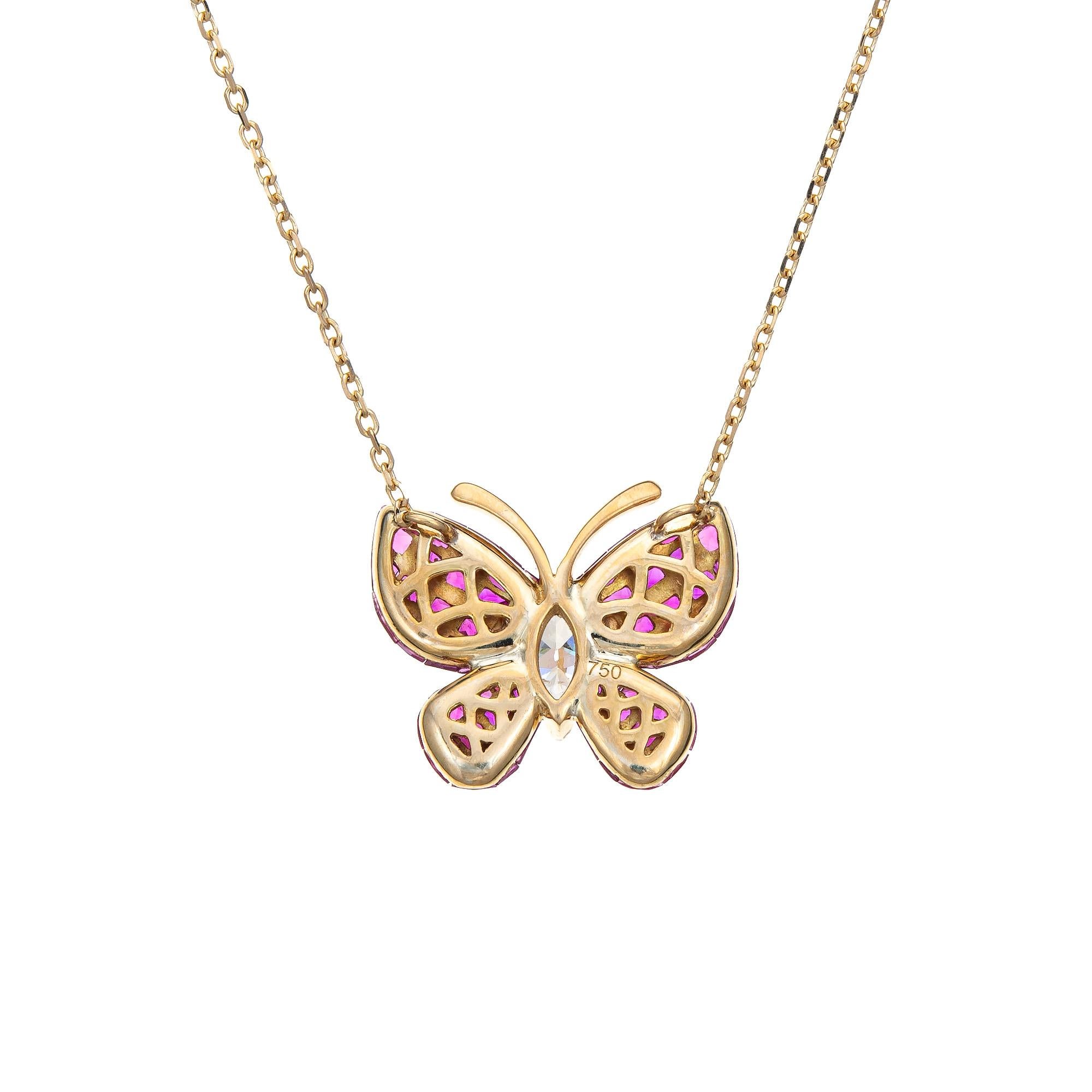 Finely detailed invisible set ruby & diamond butterfly necklace crafted in 18 karat yellow gold. 

Invisible set rubies range in size from 1.5mm to 2.5mm. One marquise cut diamond is estimated at 0.40 carats (I-J color and SI2 clarity). The rubies