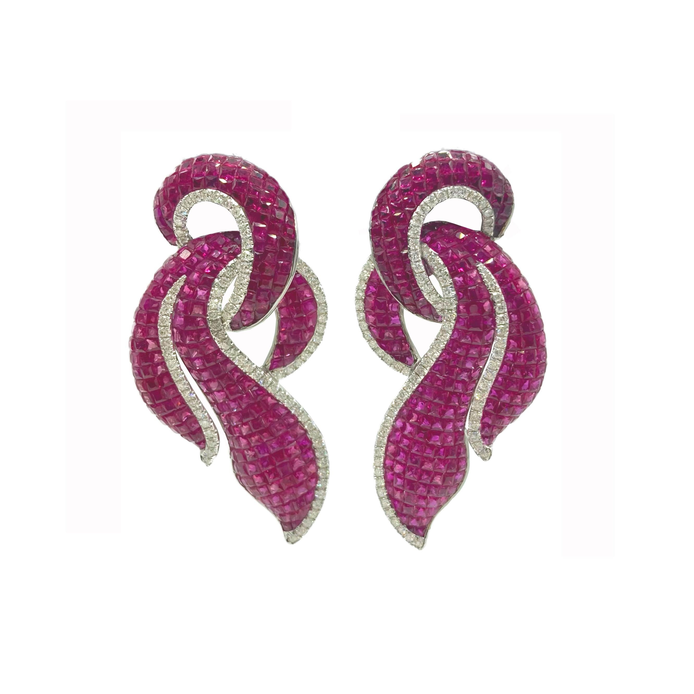 A glamorous pair of invisible set ruby and diamond earrings in 18 karat white gold.