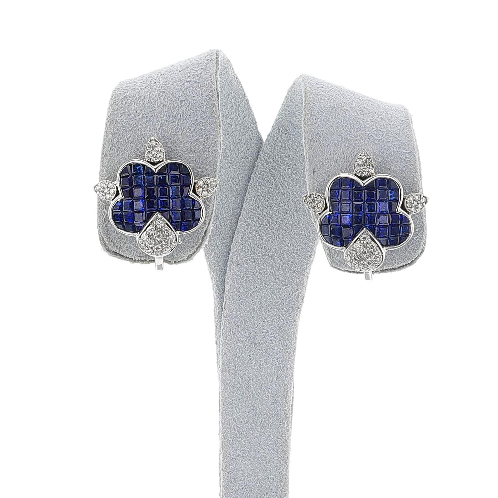 A pair of Invisible Set Sapphire and Diamond Earrings made in 18k with appx. 4.50 carats of Sapphires and 0.50 cts. of Diamonds. The total weight of the earring is 17.59 grams. The dimensions are 0.82 inches x 0.82 inches. 