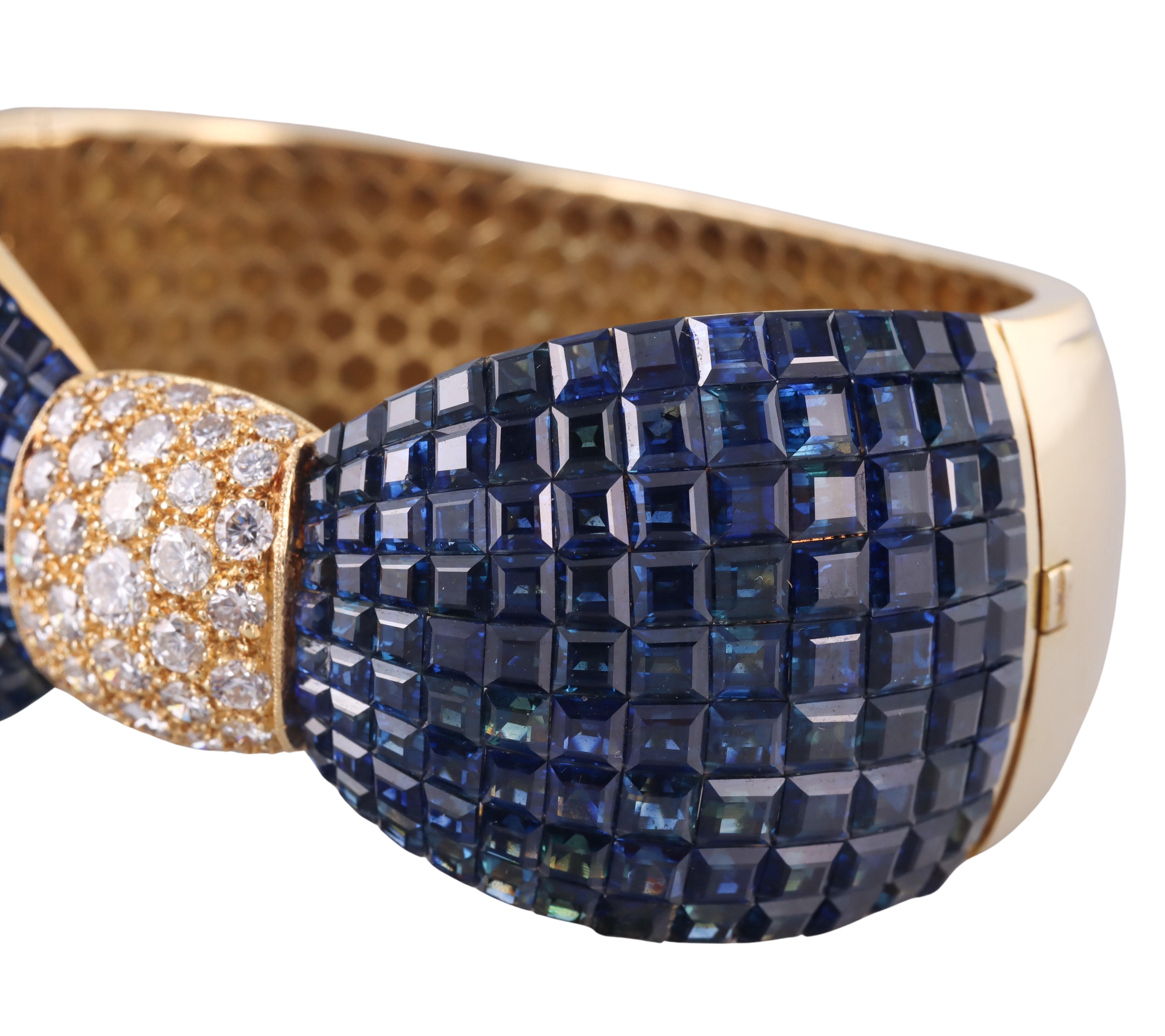 Beautiful 18k gold bow bracelet, featuring invisible set sapphires and approximately 3.00ctw SI1/H diamonds. Bracelet will fit an approximately 7