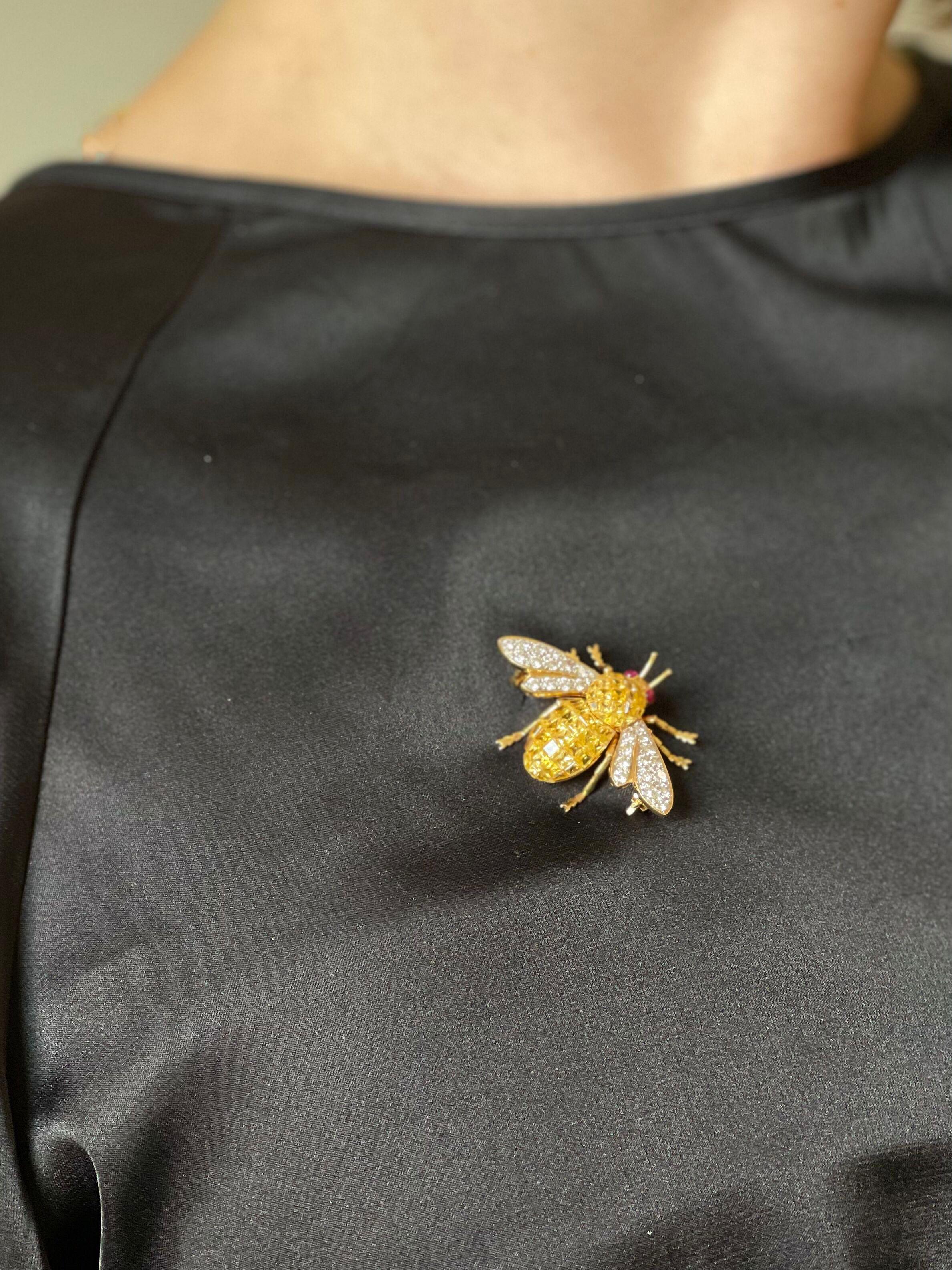 Adorable 18k gold insect bee brooch, set with ruby eyes, approx. 0.40ctw H/VS diamonds and invisible set yellow sapphires. Brooch measures 1 1/8