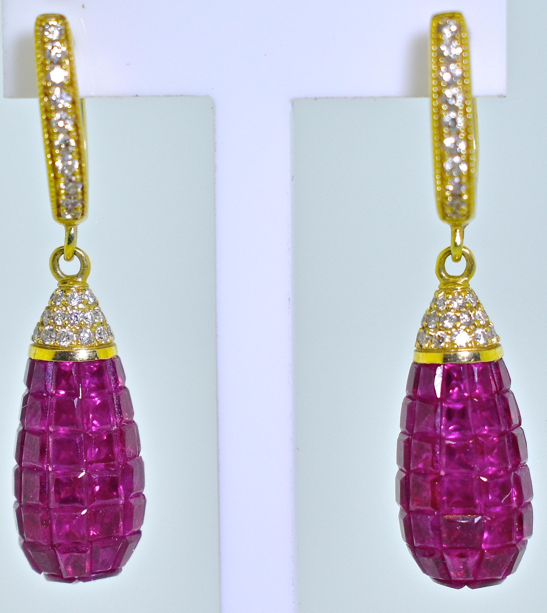 Rubies - bright and lively and fancy cut, invisibly set in a drop.  There are approximately 10 cts., of natural rubies suspended from 18K gold earrings which are set throughout with .80 cts. of fine white diamonds,  (G/H,VS1), near colorless and