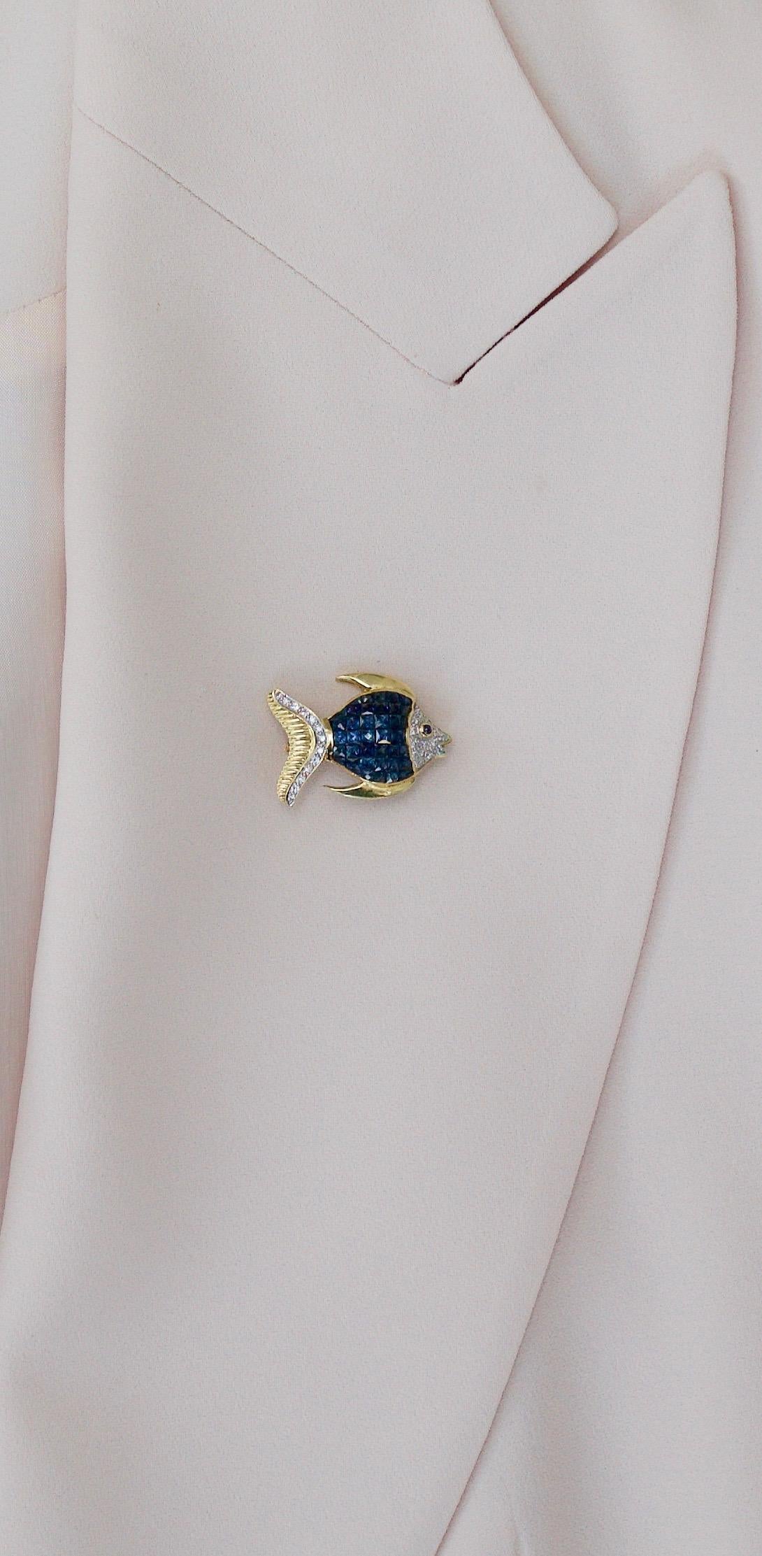 Invisibly Set Sapphire and Diamond Fish Brooch in 18k Yellow Gold
Designed Depicting a Typical Fish You Will See Snorkeling In Front of Our Salon in Maui
Thirty Nine Fancy French Cut Sapphires  Weighing 5.01 Carats [before cutting] 
Twelve Round