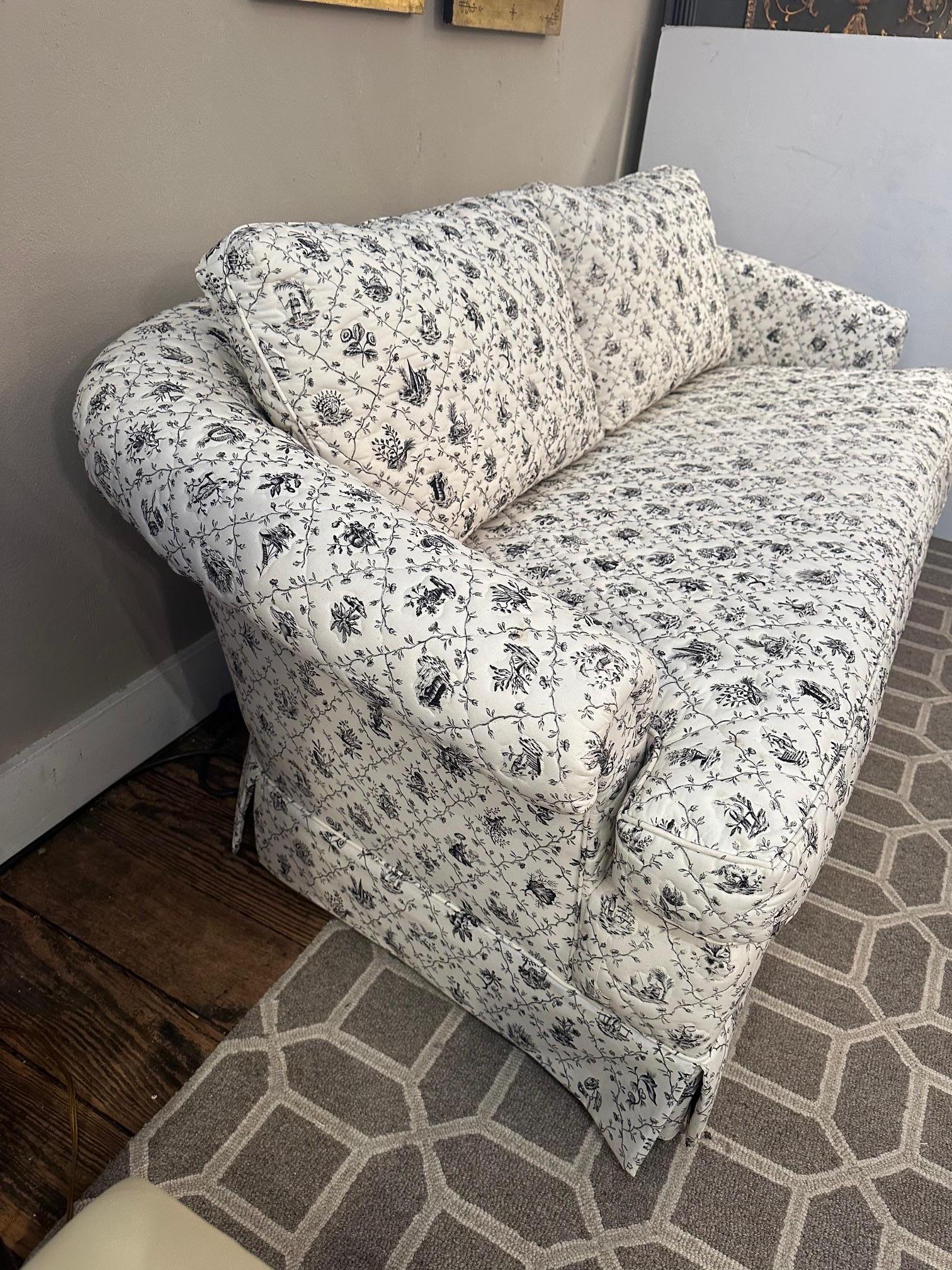 Inviting elegant upholstered loveseat having quilted black and white toile inspired fabric.  Super comfy.
Arm 23” H
Seat with back pilllows 18” D
W/out pillows 24” D
Seat height 18”
