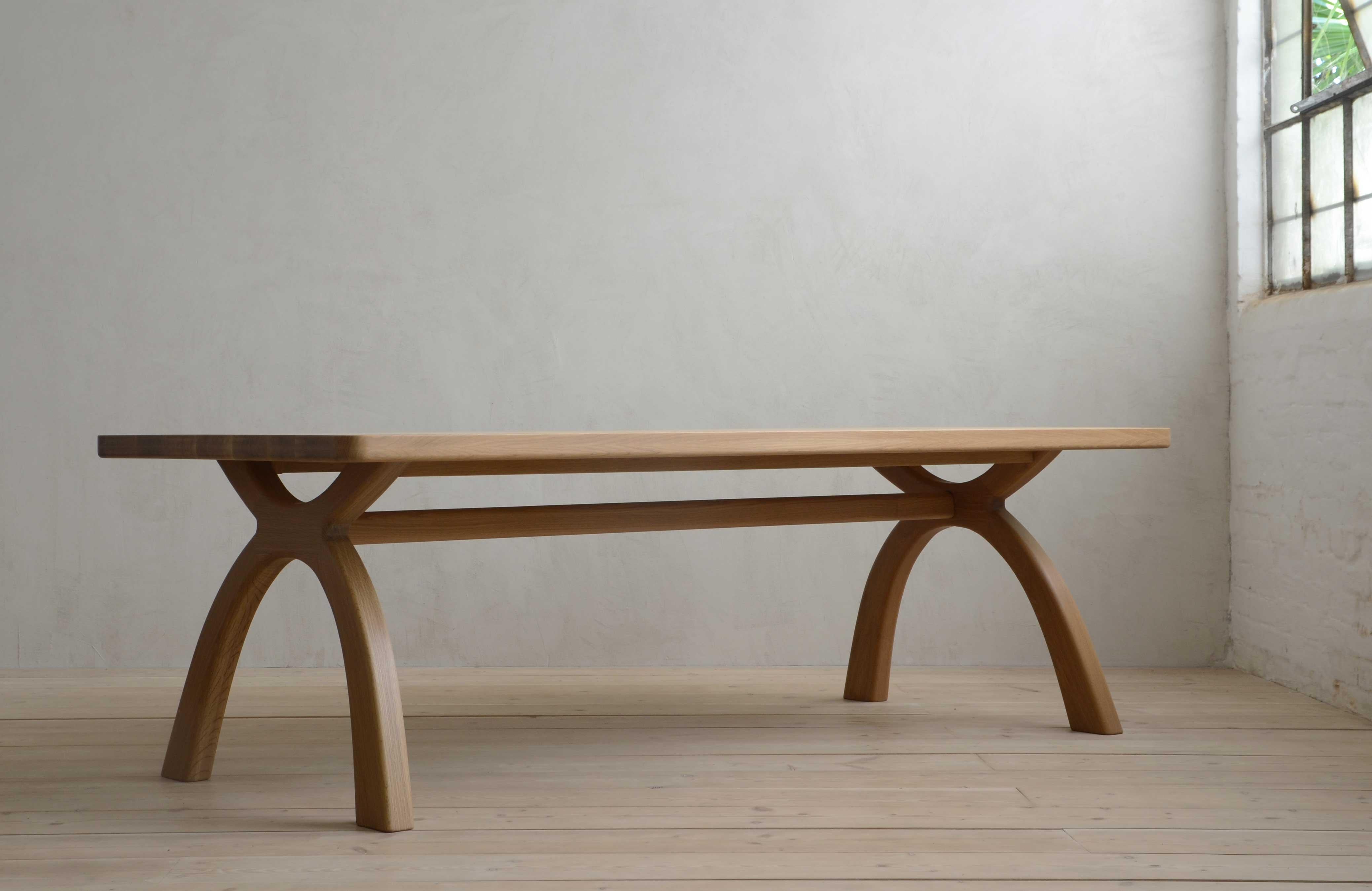 The original piece in the Inyo Collection.  Arched legs transition smoothly into thick, solid-wood top