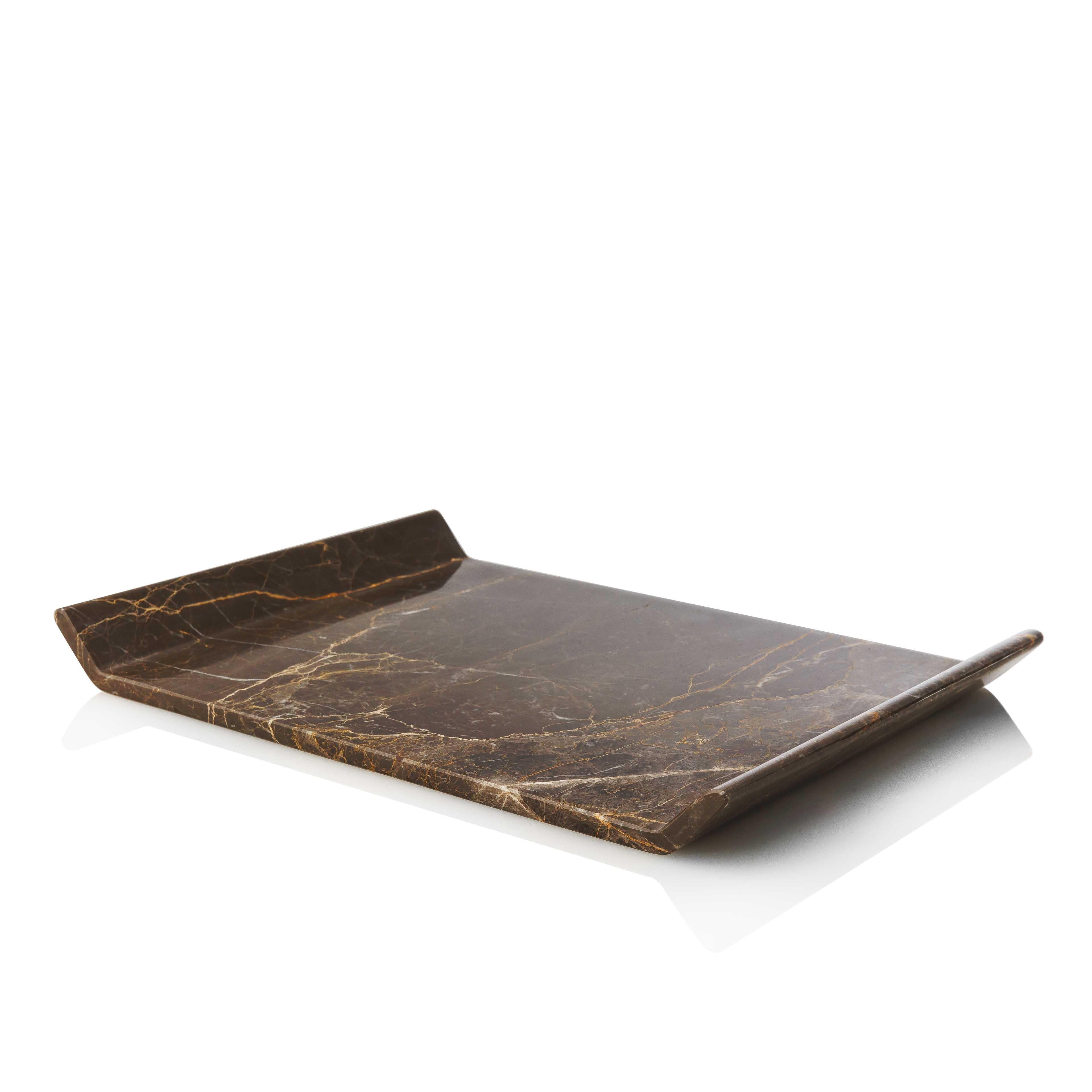 This platter is designed as a homogeneous volume, wishing to engage the senses around the plasticity of marble. It is carved off a single piece of marble without joints or seams.

Io platter has a fine mat finish, revealing the unique color and