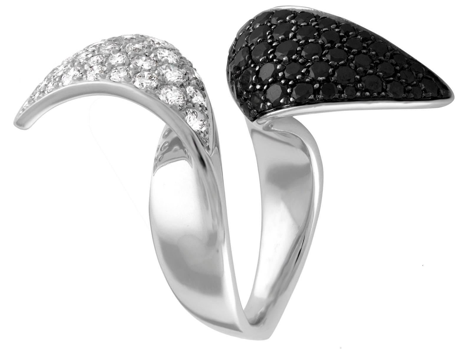 Very Unusual Bypass Ring
The ring is 18K White Gold
There is 2.50 Carats in Black Diamonds
There is 2.25 Carats in White Diamonds F VS
The ring is by an Italian Designer IO SI Scavia.
The ring is made in Italy.
The ring measures 1.5