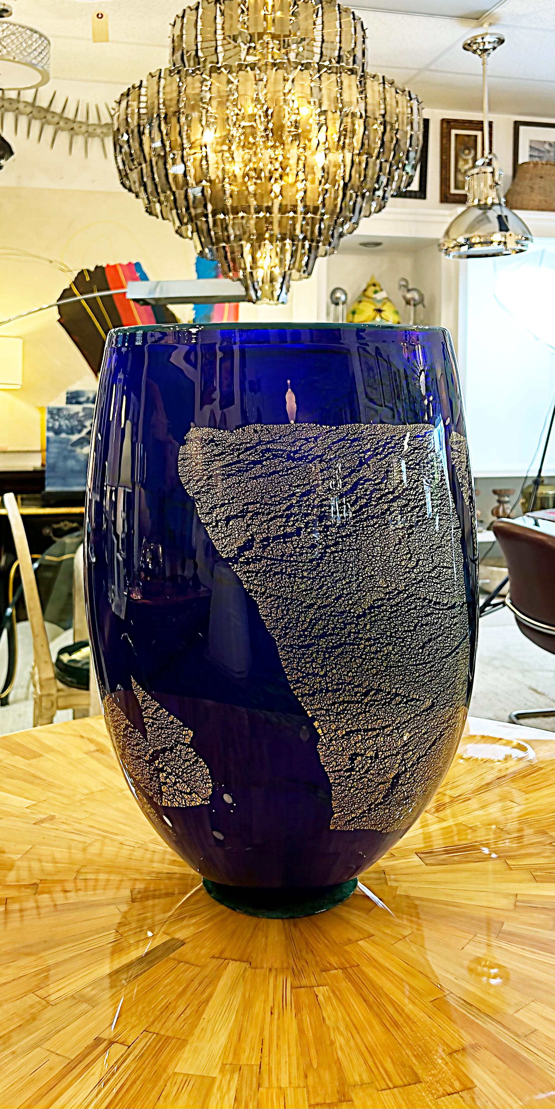 Ioan Nemtoi Modern Monumental Studio Art Glass Vase, Bucharest, Romania

Offered for sale is a large and quite substantial studio-blown art glass vase by Ioan Nemoti of Bucharest, Romania. The blue vase is dramatic with large gold-infused accents