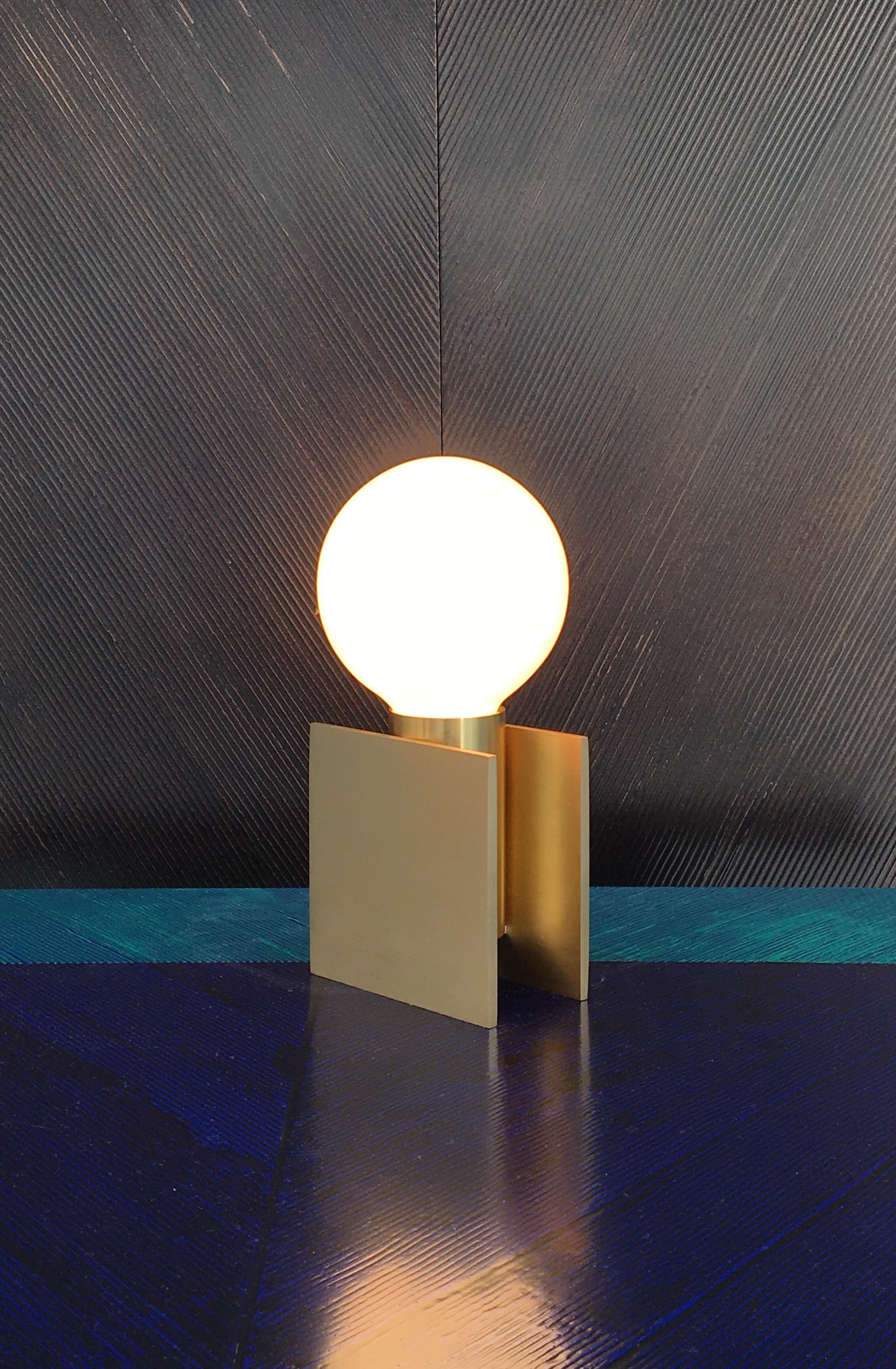 IOI lamp by SB26
Dimensions: W 9.7 x D 9.1 x H 19.2 cm
Materials: Brushed brass structure, varnished finish
 Possibility of patinated brass

IOI is a small table lamp composed from a graphic game of simple shapes. An iconic silhouette with its