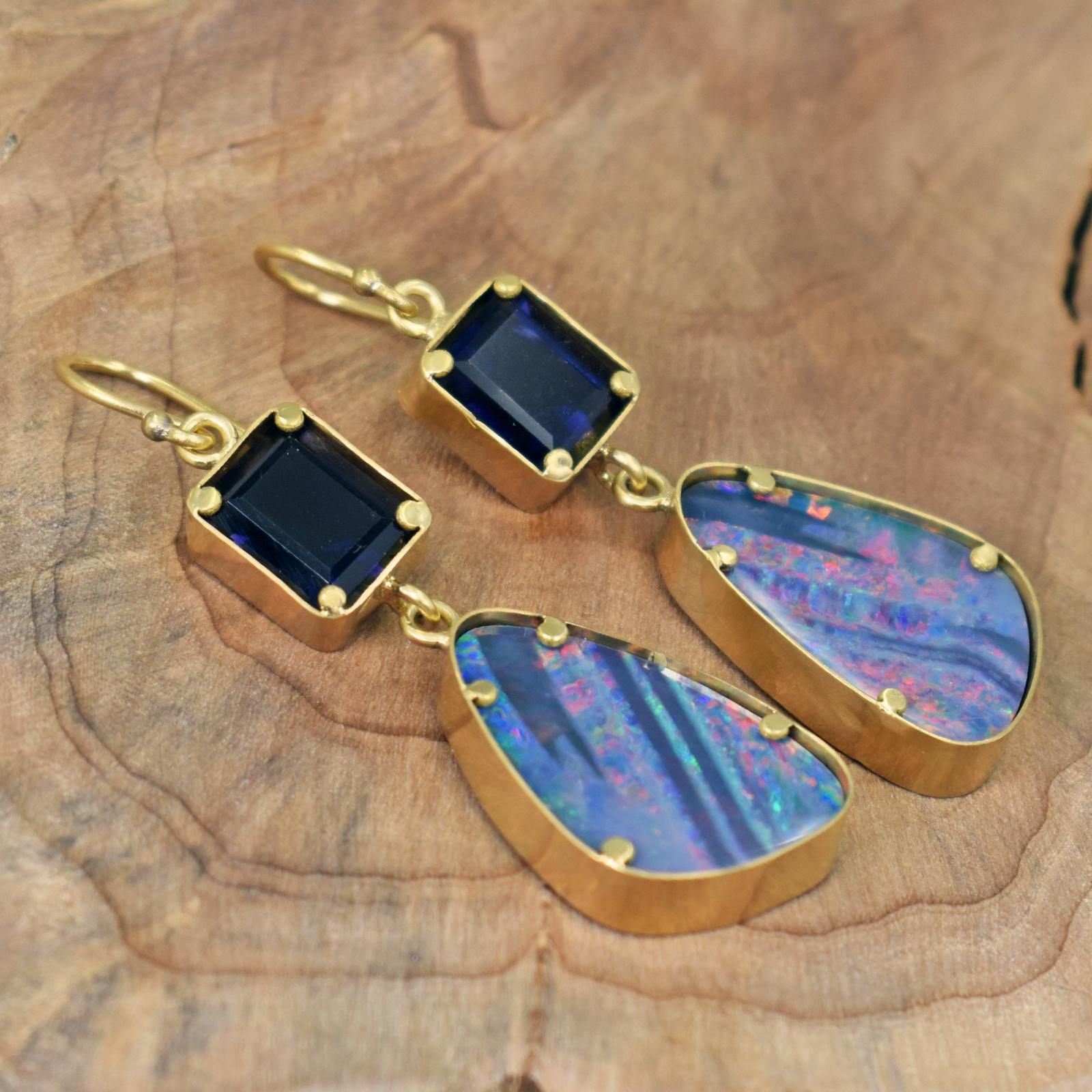 Two tier, hand forged 22k yellow gold dangle earrings featuring Emerald / Octagon cut, deep violetish-blue Iolite (7.7 cttw) and beautiful Australian Boulder Opal (18.6 cttw) gemstones. Dangle earrings are 2.25 inches in total length, including