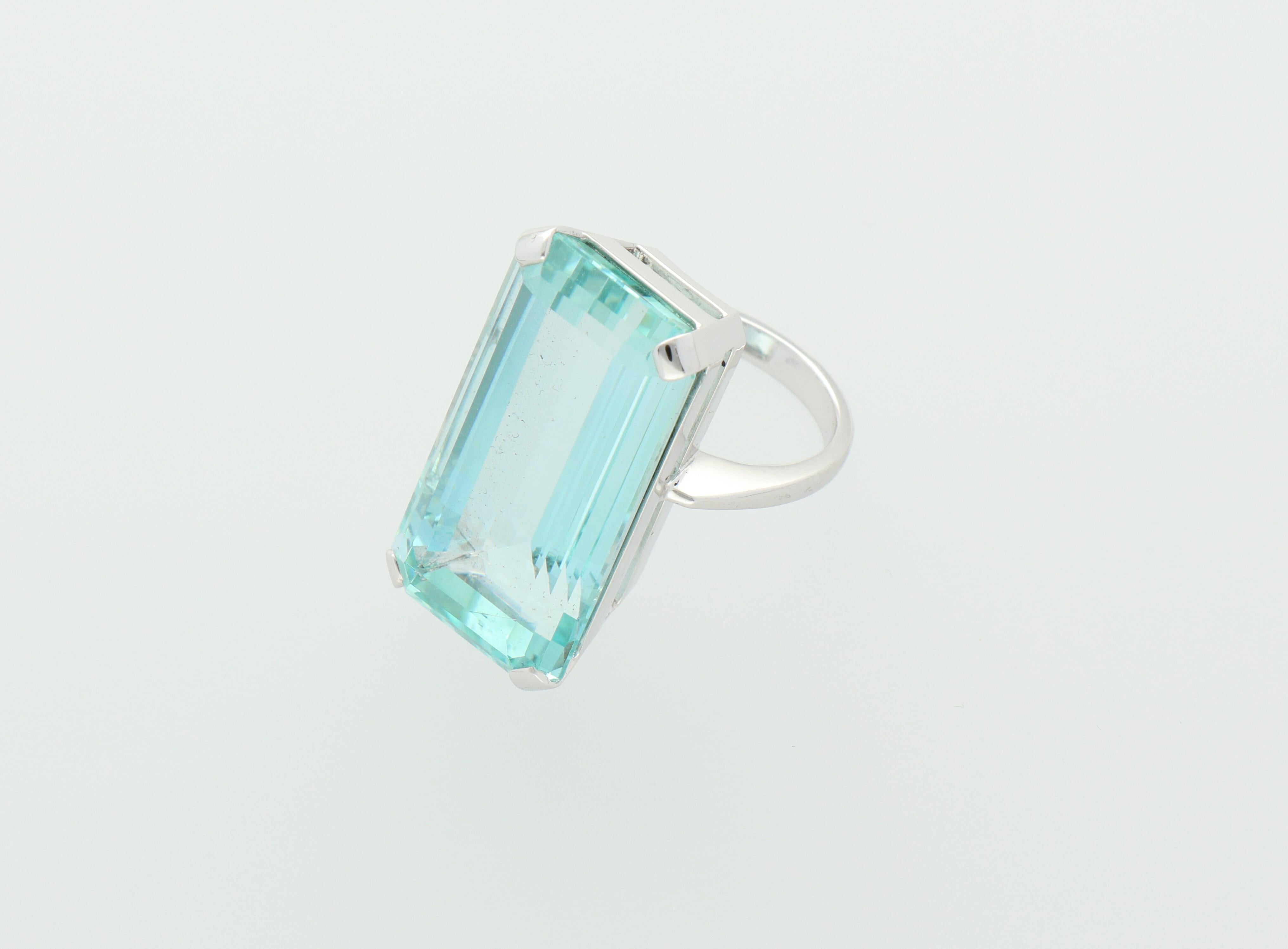 A beautiful blue colour emerald cut Aquamarine, weighing 38.4 carats,  mounted in 18K white gold cocktail ring.

Size METRIC 54 AMERICAN 7
Components:
18K white gold - 10.7 grams
Aquamarine - 38.4 carat
